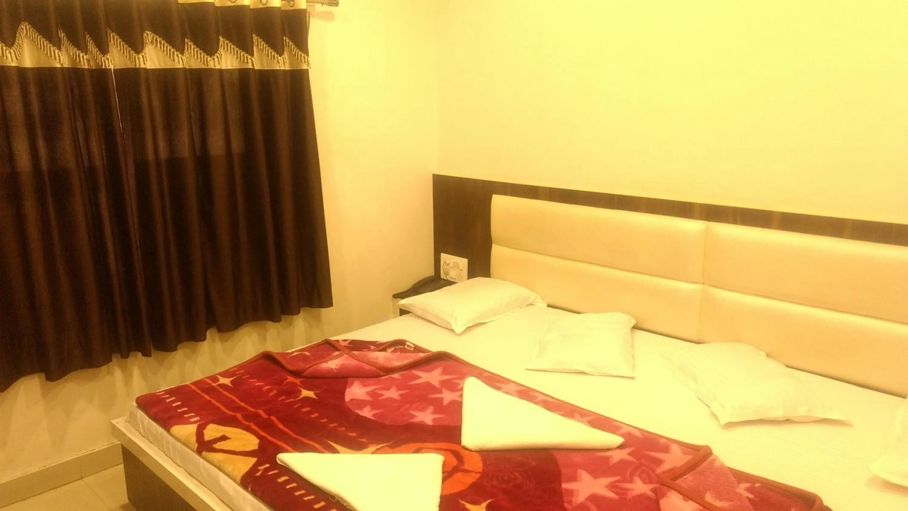 Bed in Ashiyana Inn Hotel
