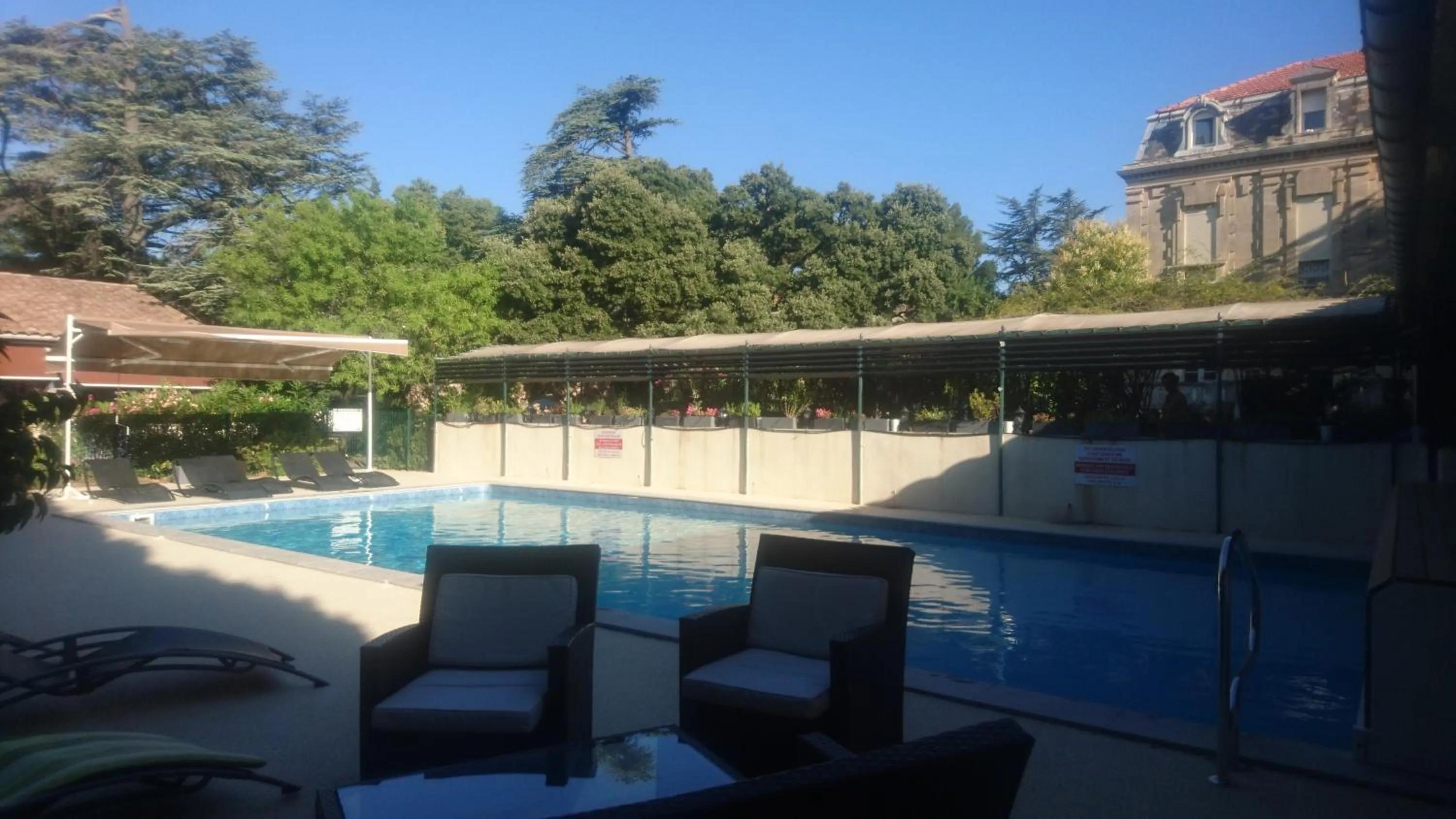 Swimming pool in Logis Hôtel - Restaurant Résidence Les Cèdres