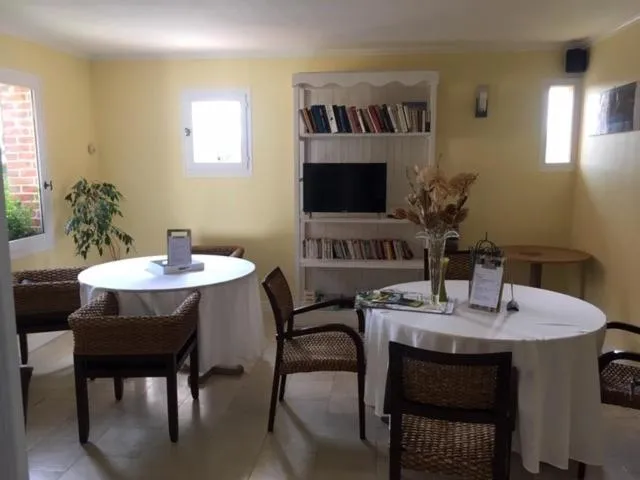 Communal lounge/ TV room in Logis Hotel Le Nuage