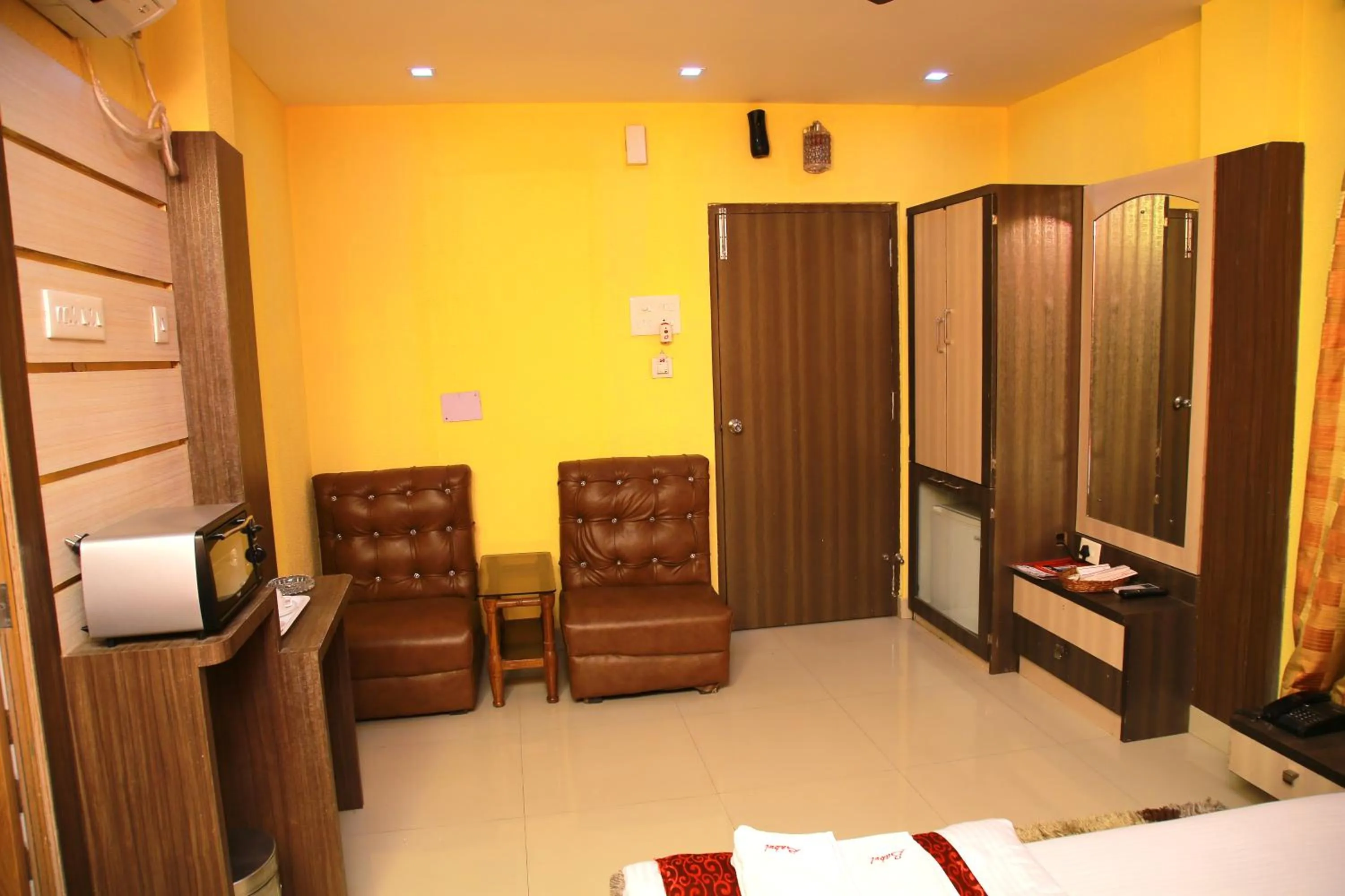 Seating area, Bed in Babul Hotel