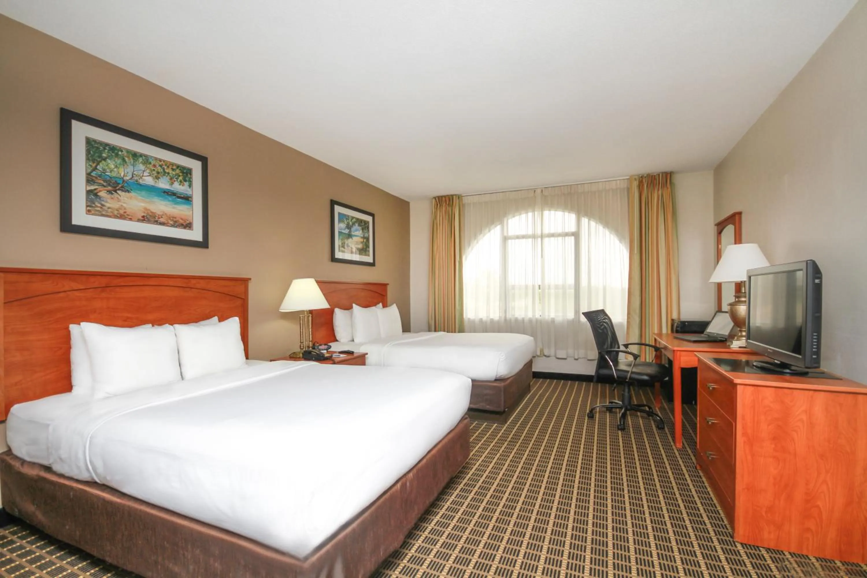 Bed in Clarion Inn & Suites Miami International Airport
