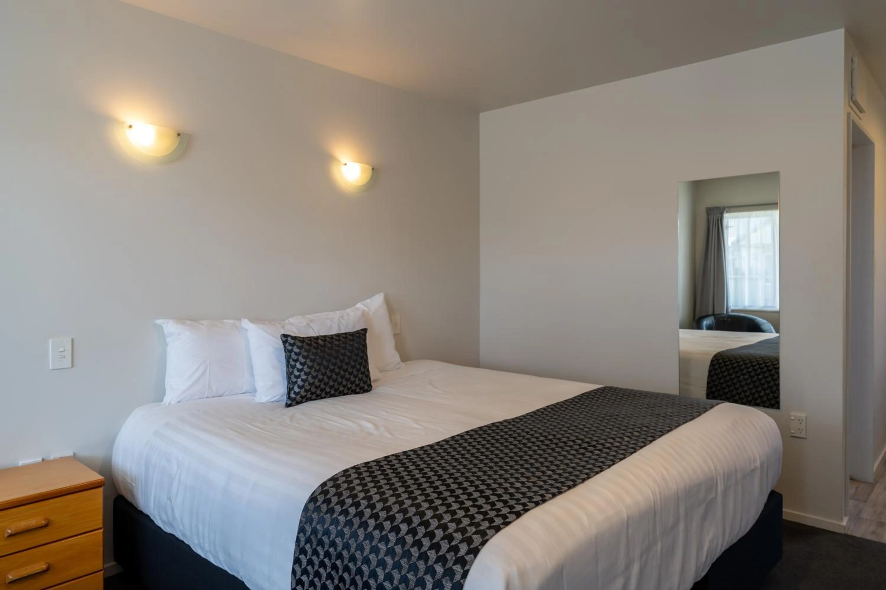 Bed in ASURE Gables Motor Lodge