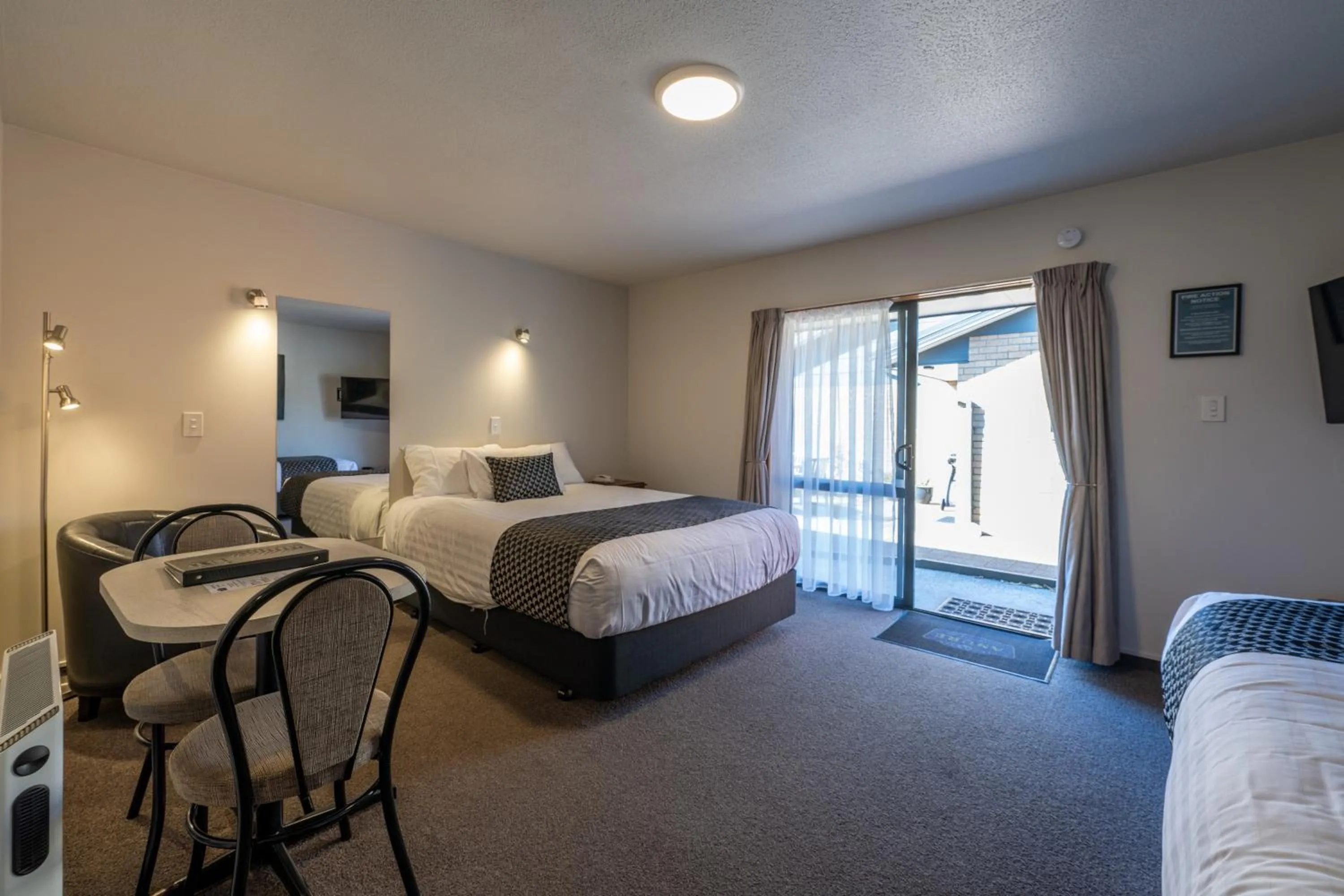 Bed in ASURE Gables Motor Lodge