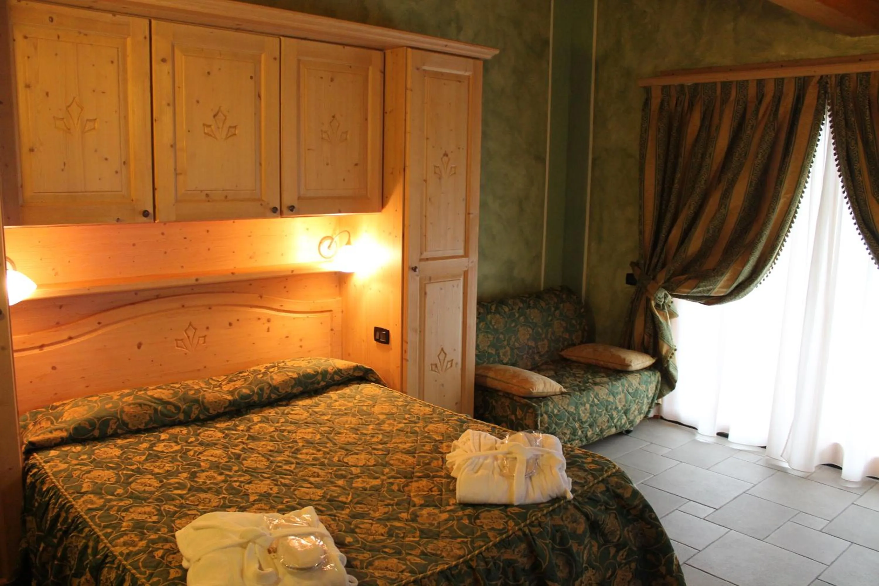 Bed in Boscone Suite Hotel