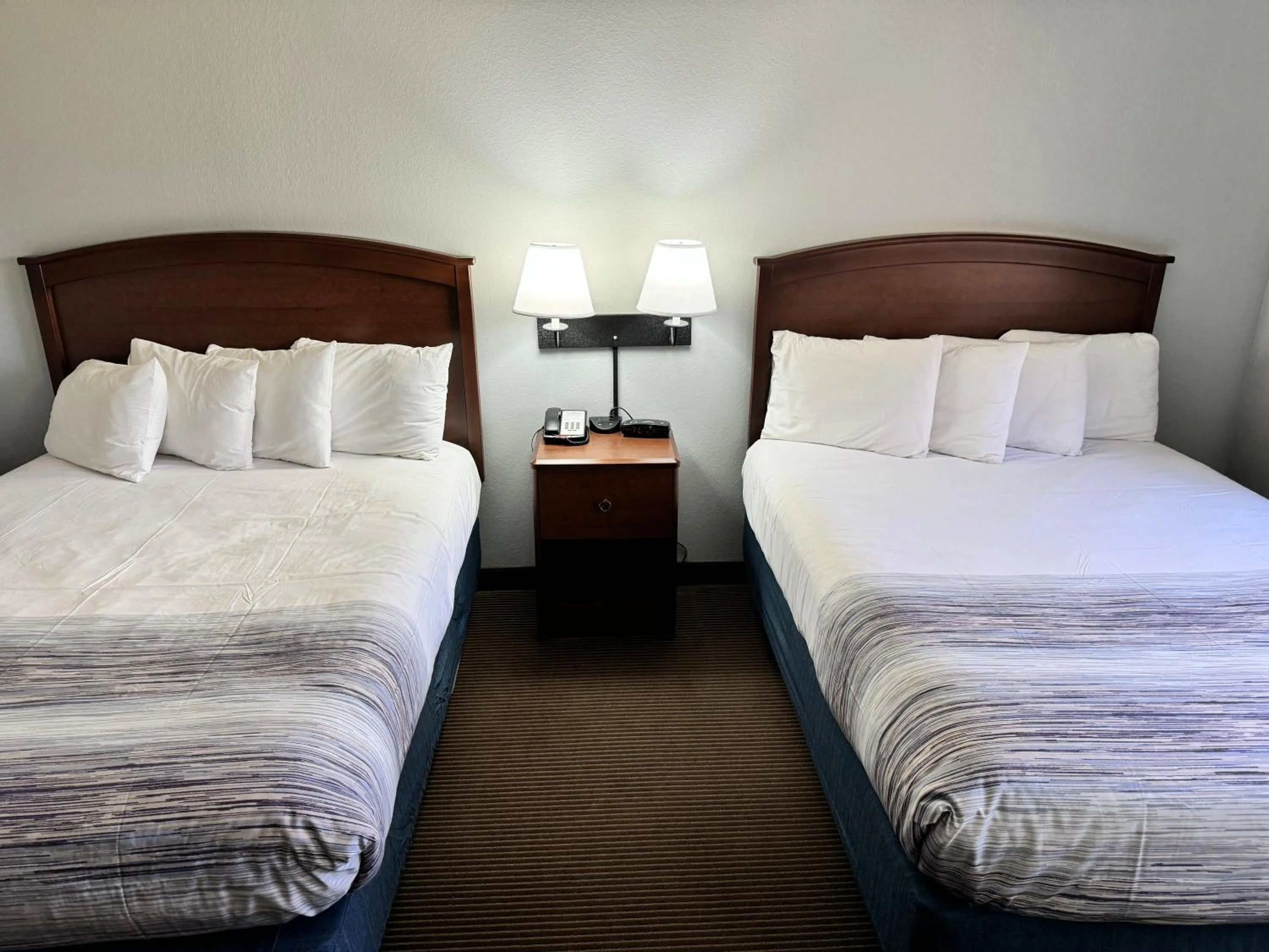 Bed in AmericInn by Wyndham Stillwater