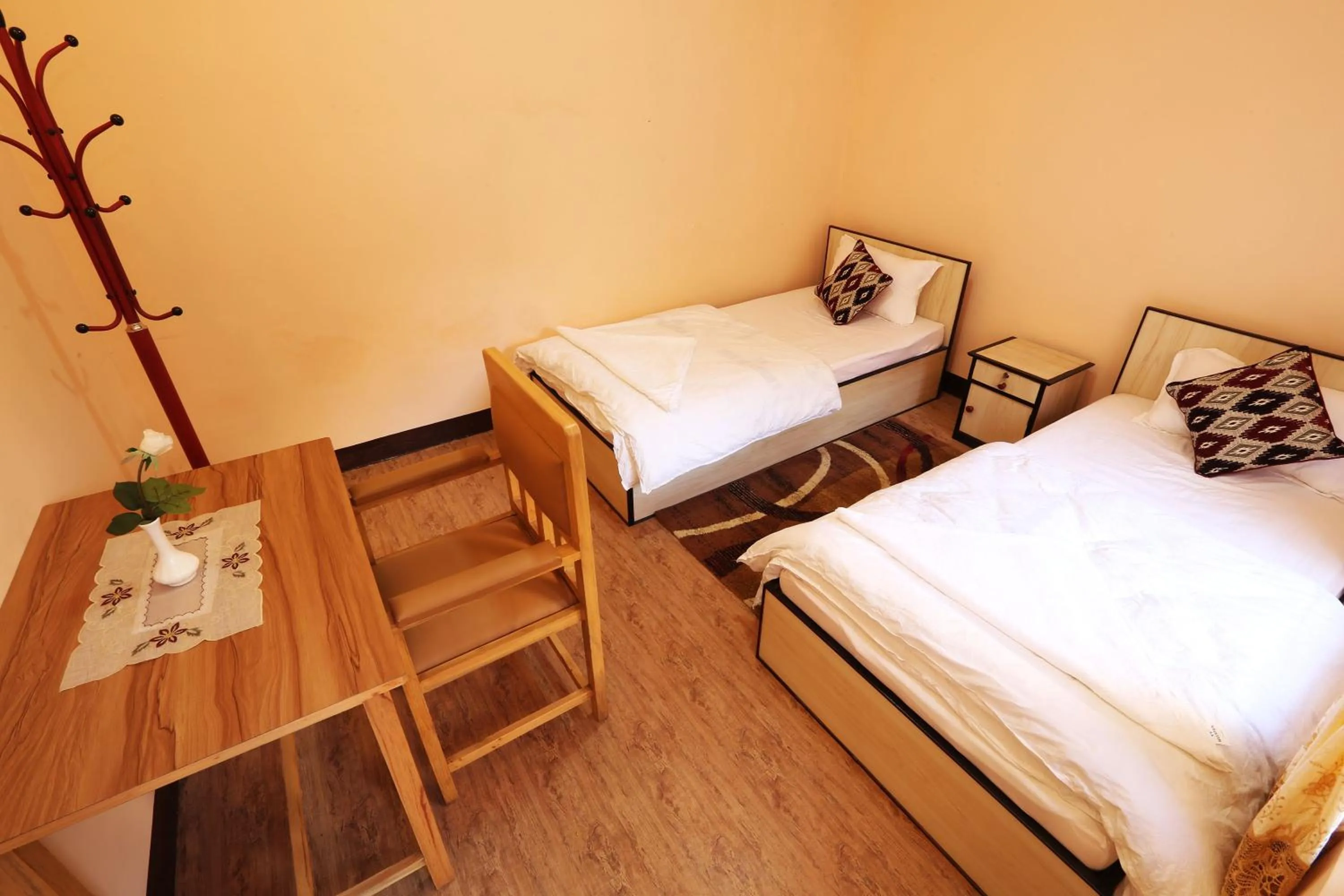 Seating area, Bed in Aarya Chaitya Inn