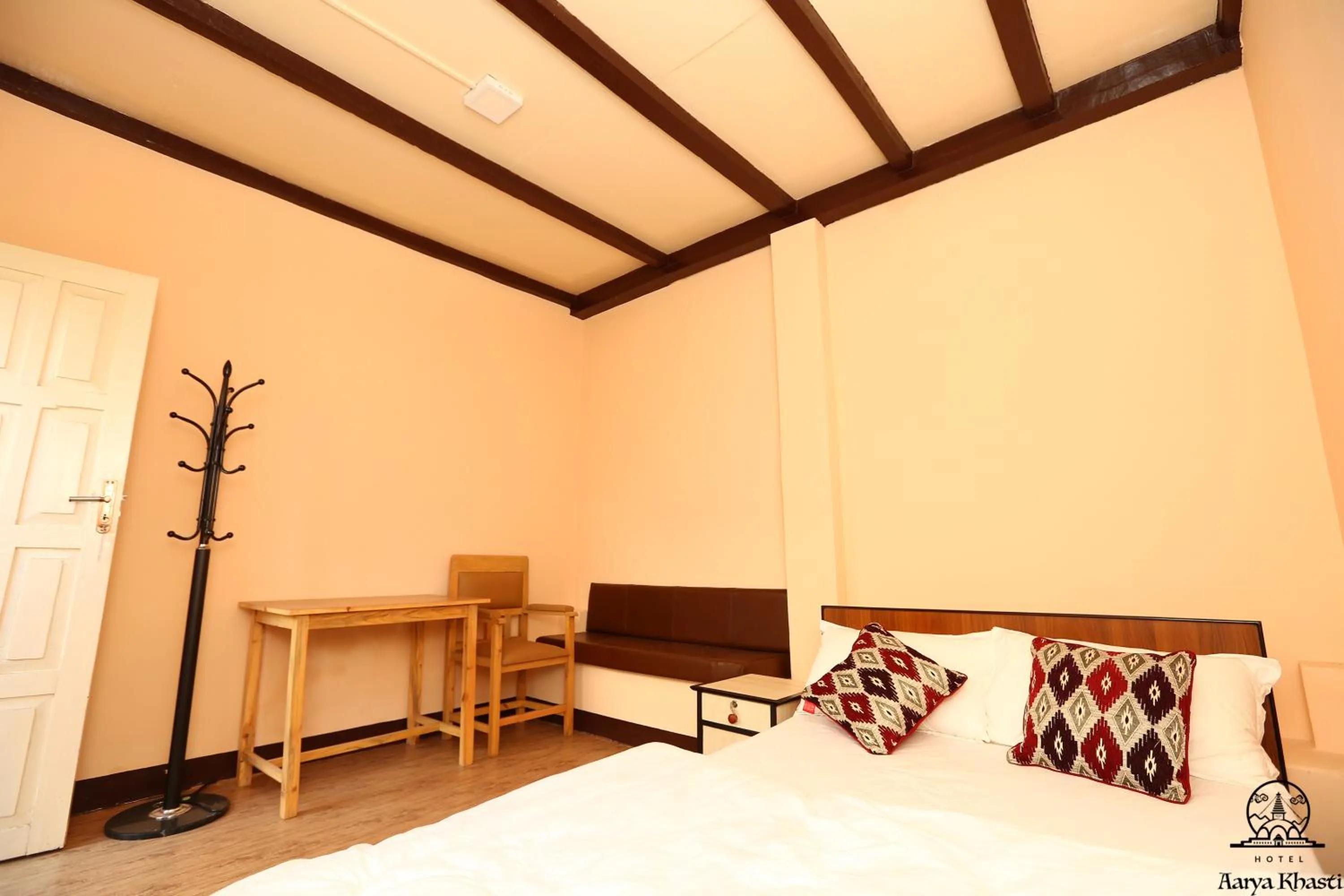 Seating area, Bed in Aarya Chaitya Inn