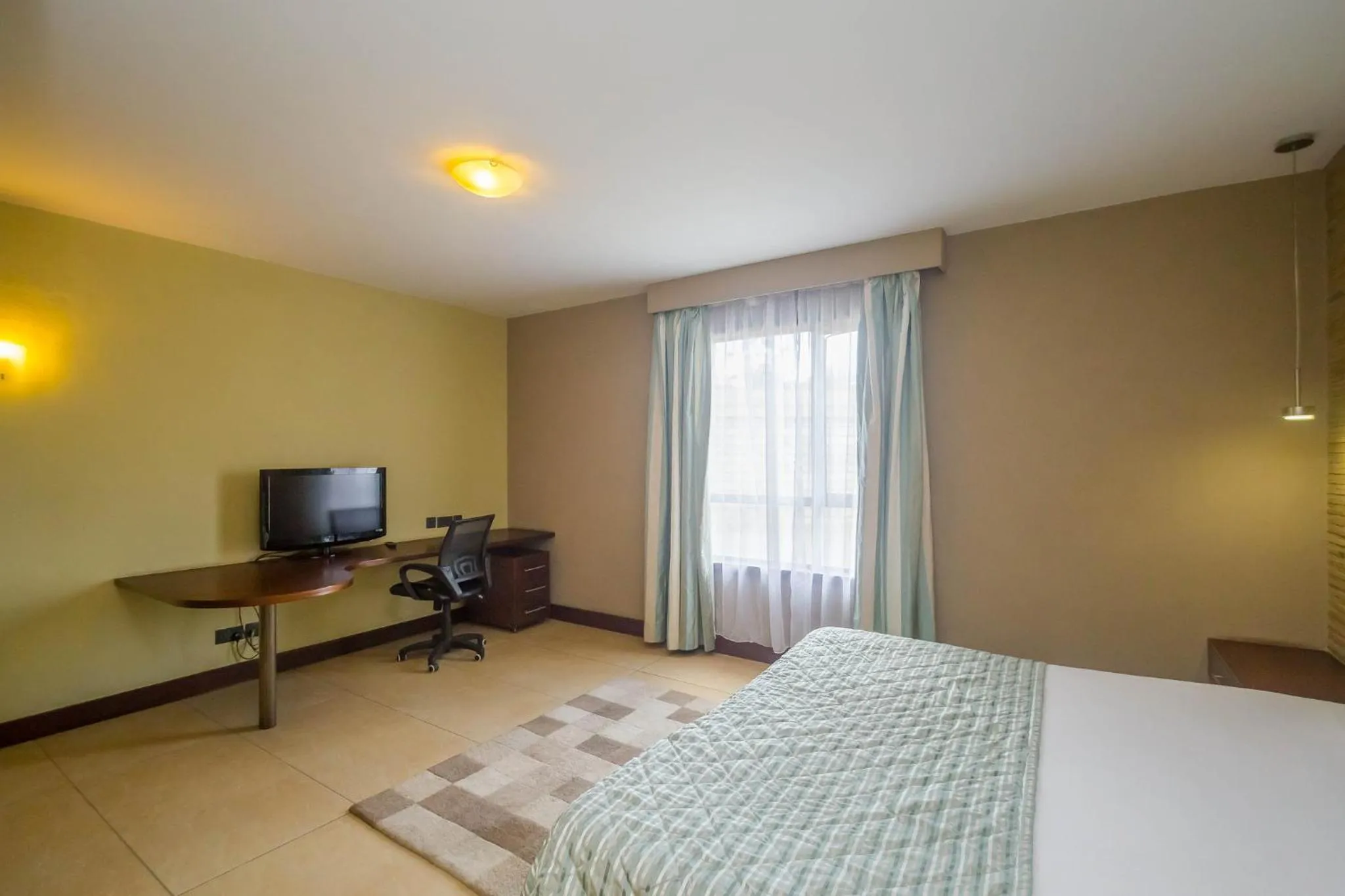 Photo of the whole room, Bed in Taarifa Suites by Dunhill Serviced Apartments
