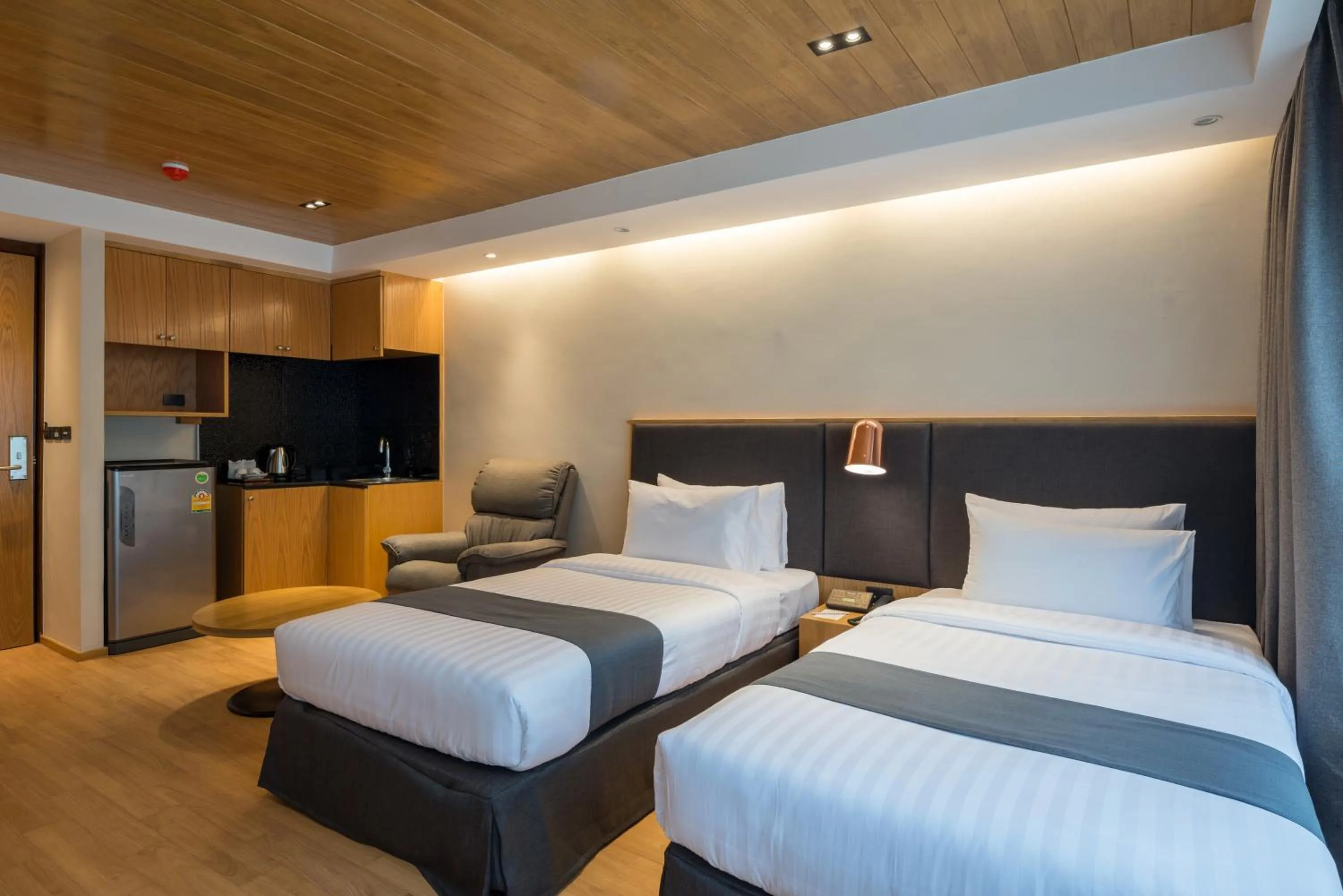 Kitchen or kitchenette, Bed in Asana Hotel & Residence