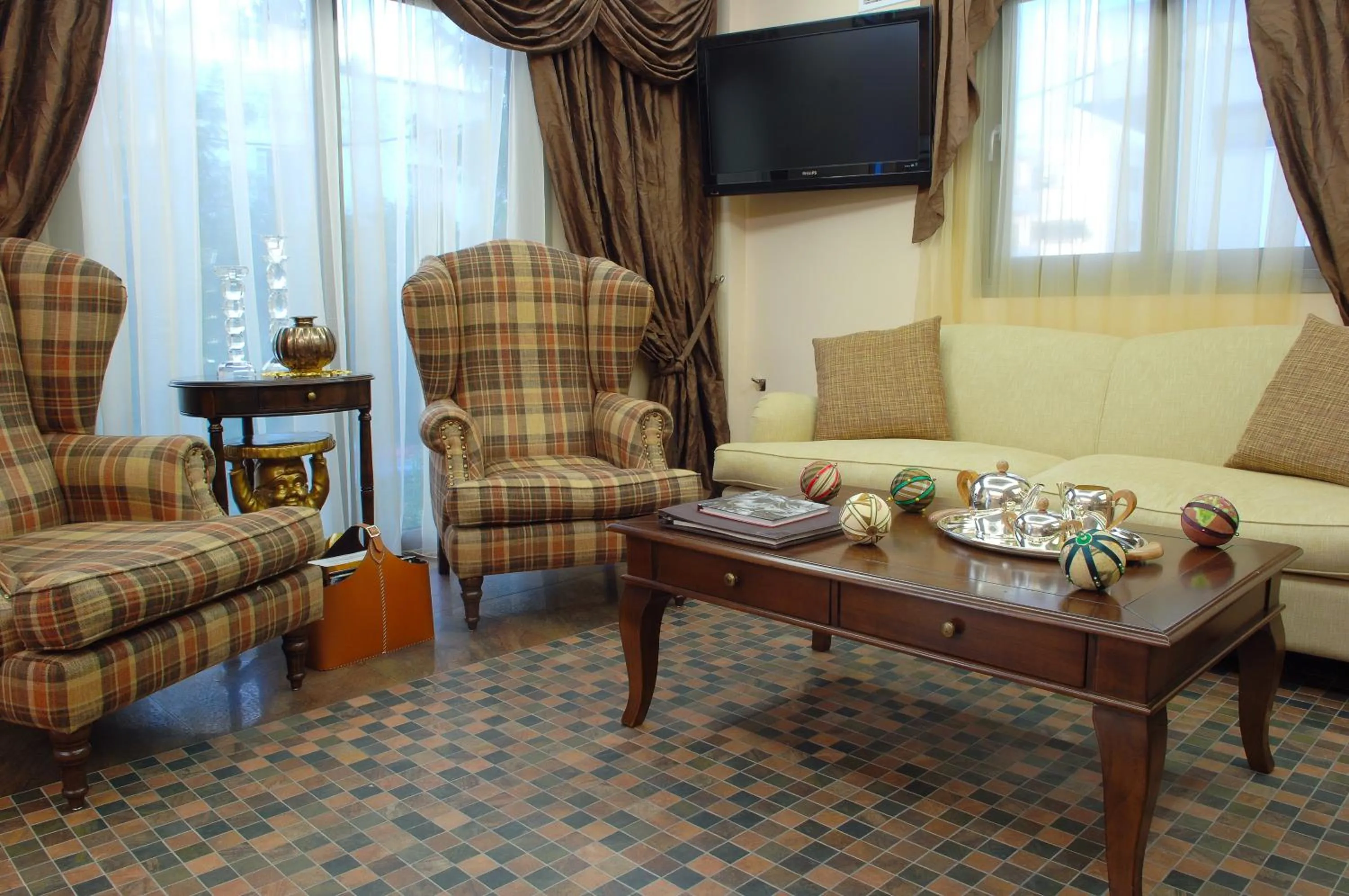 Communal lounge/ TV room in Olympic Fashion Hotels