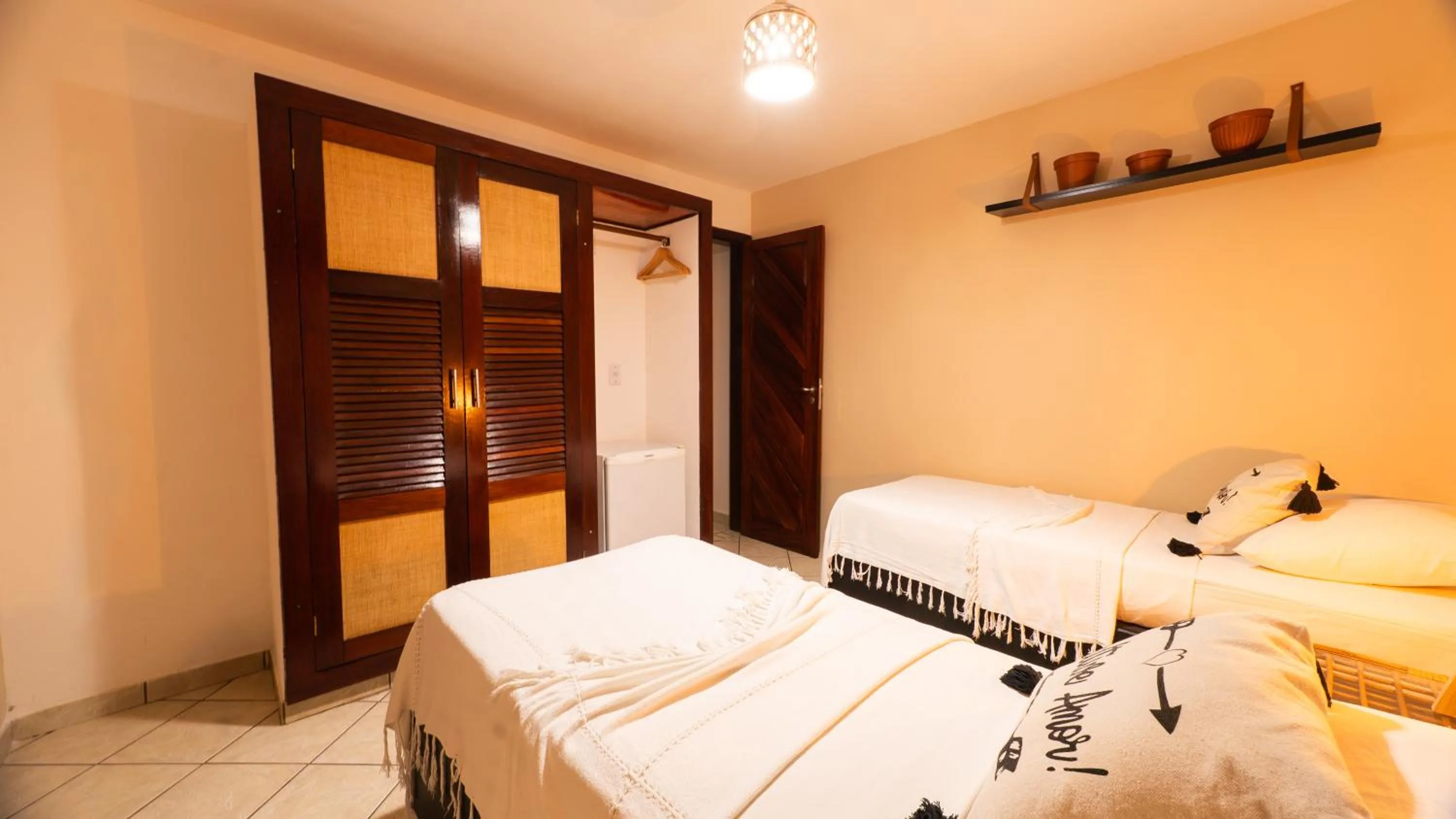 Bed in Pousada Bicho Preguiça