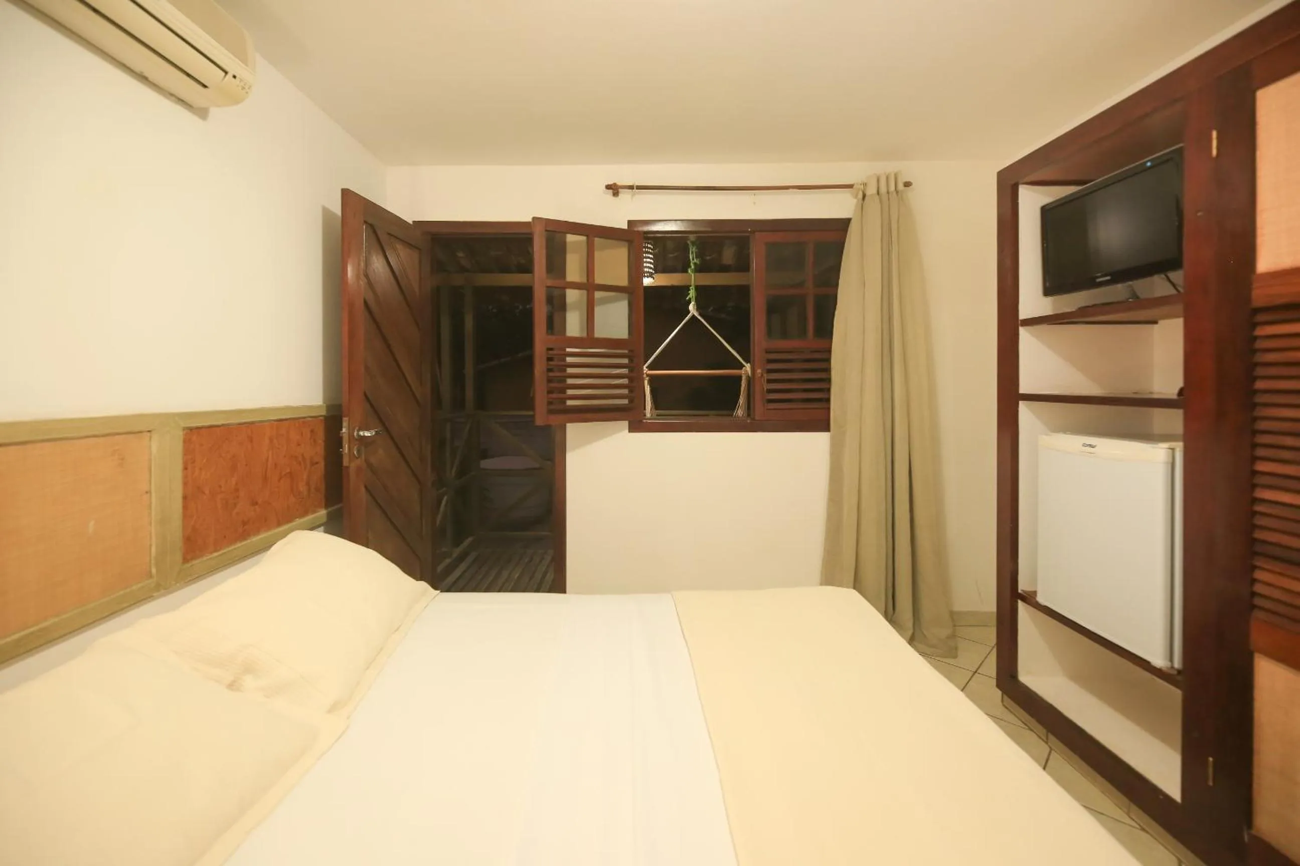 Bed in Pousada Bicho Preguiça