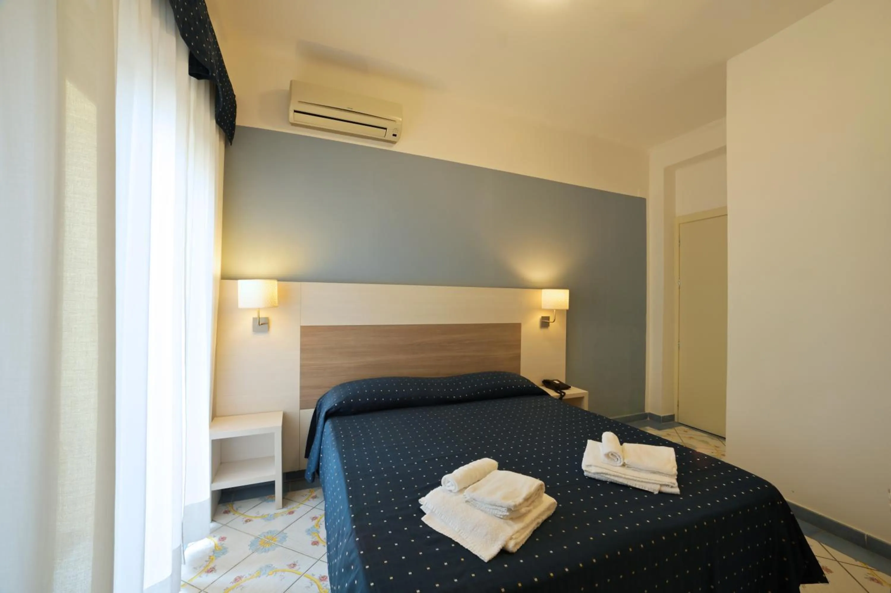 Bed in Hotel Delfino