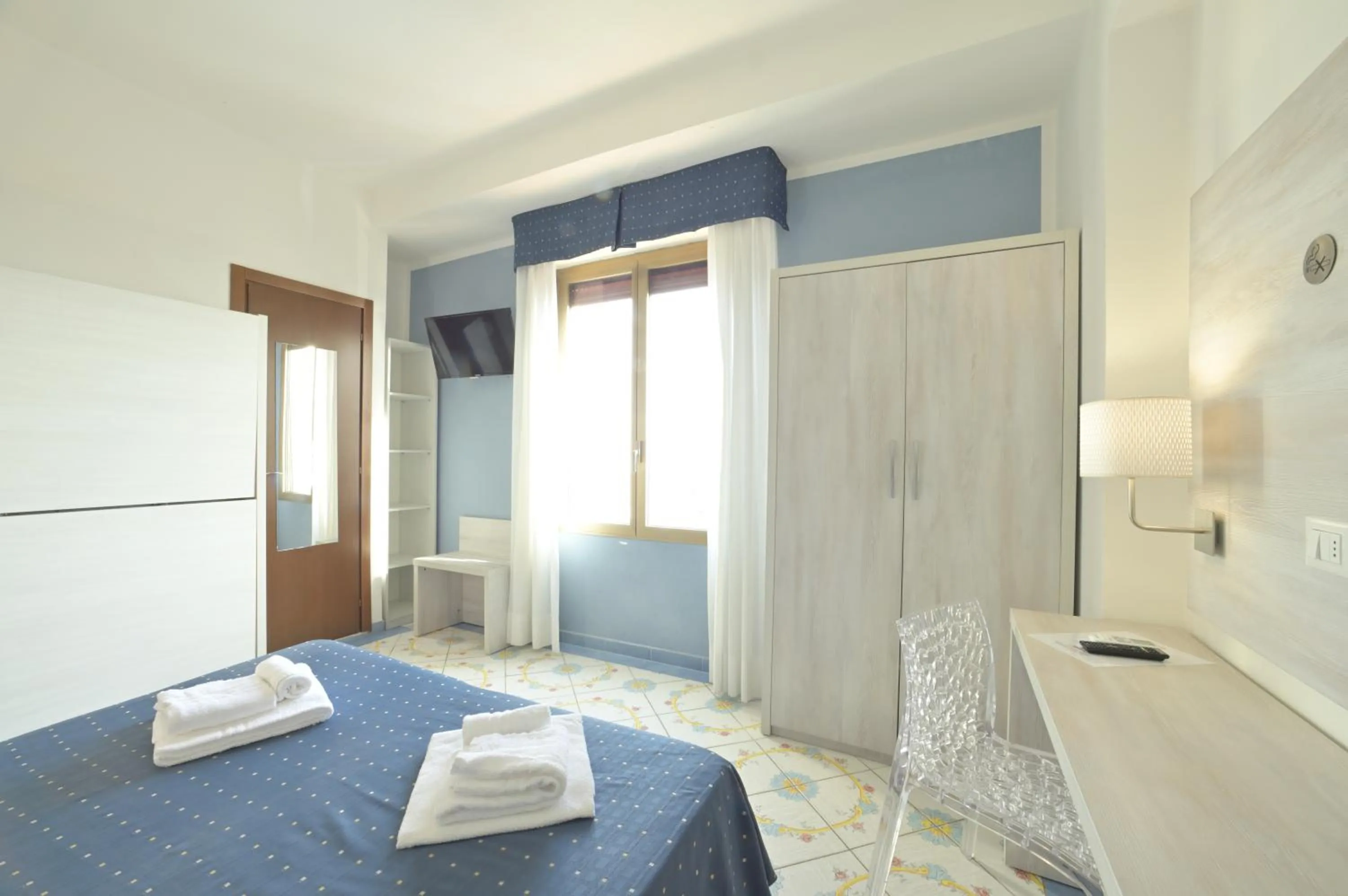 Bed in Hotel Delfino