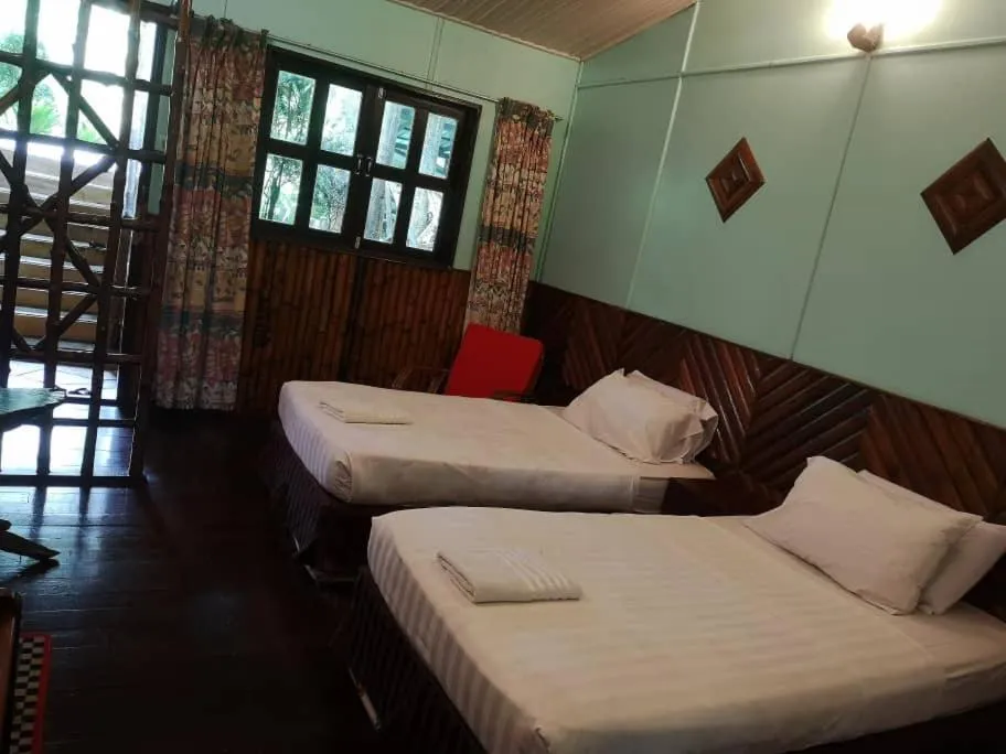 Bed in Sepilok Jungle Resort