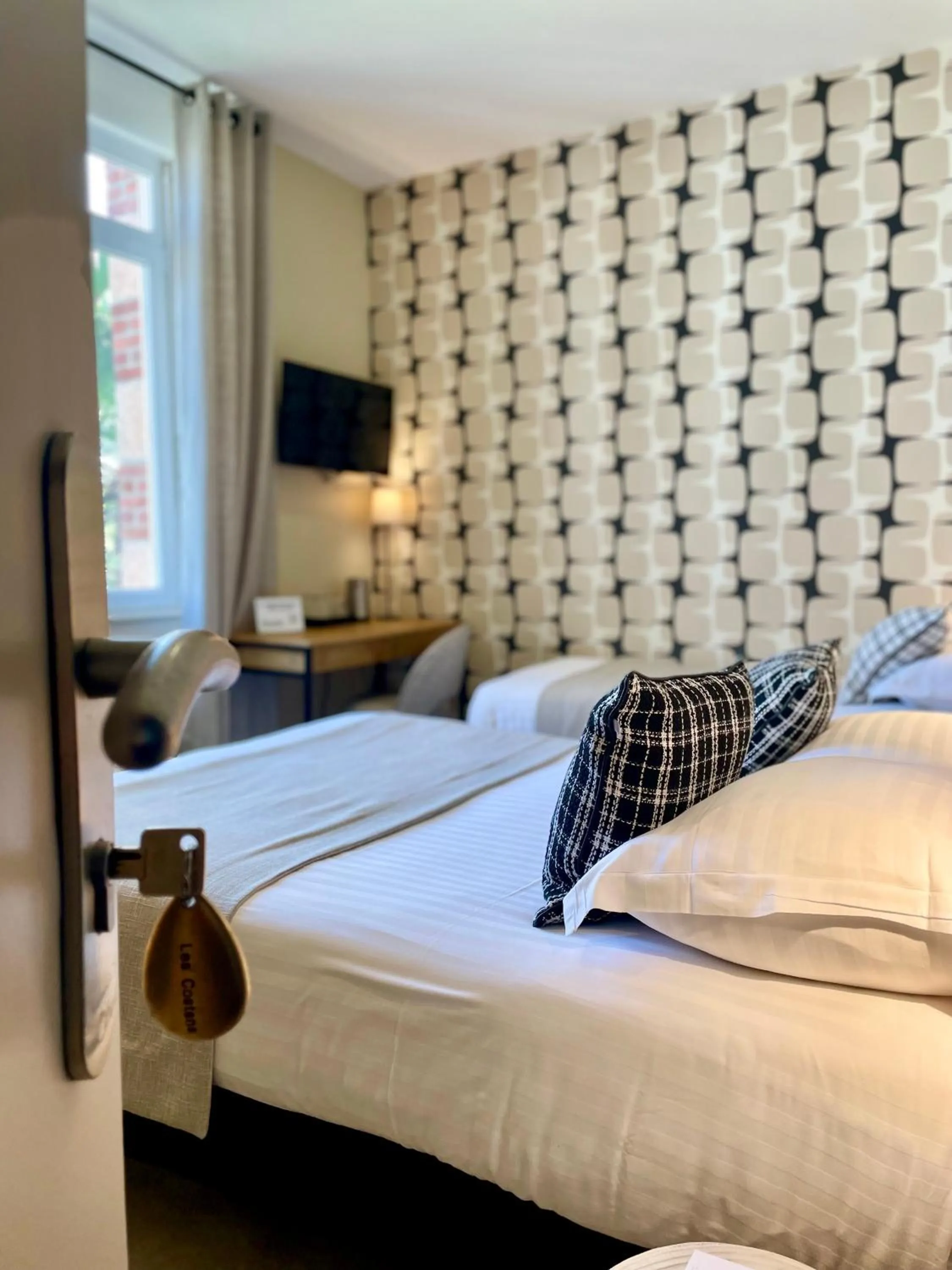 Bed in Hôtel Les Costans, The Originals Relais