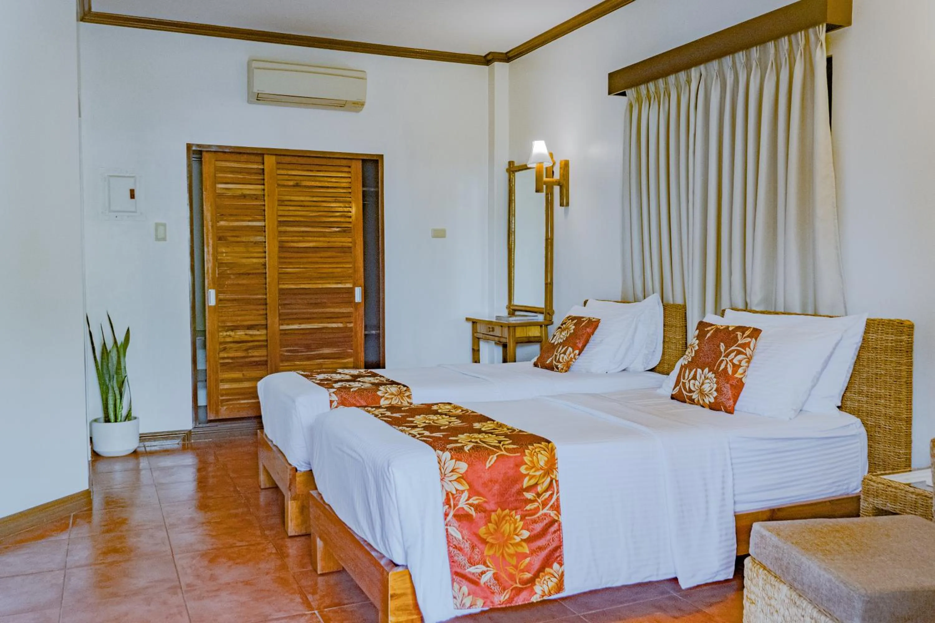 Bed in Pura Vida Beach & Dive Resort