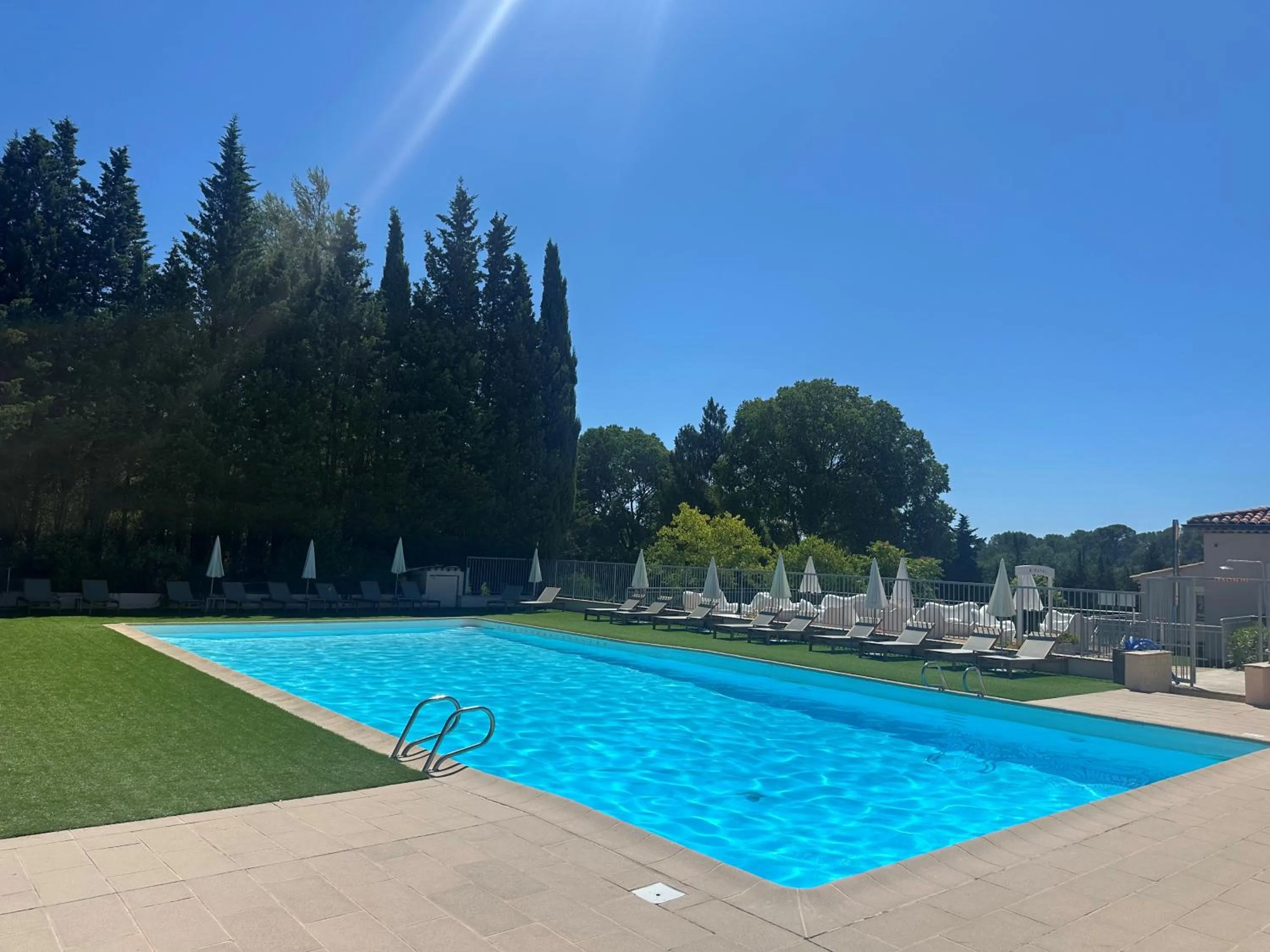 Swimming pool in Hôtel Golf & Spa Château de la Bégude The Originals Collection