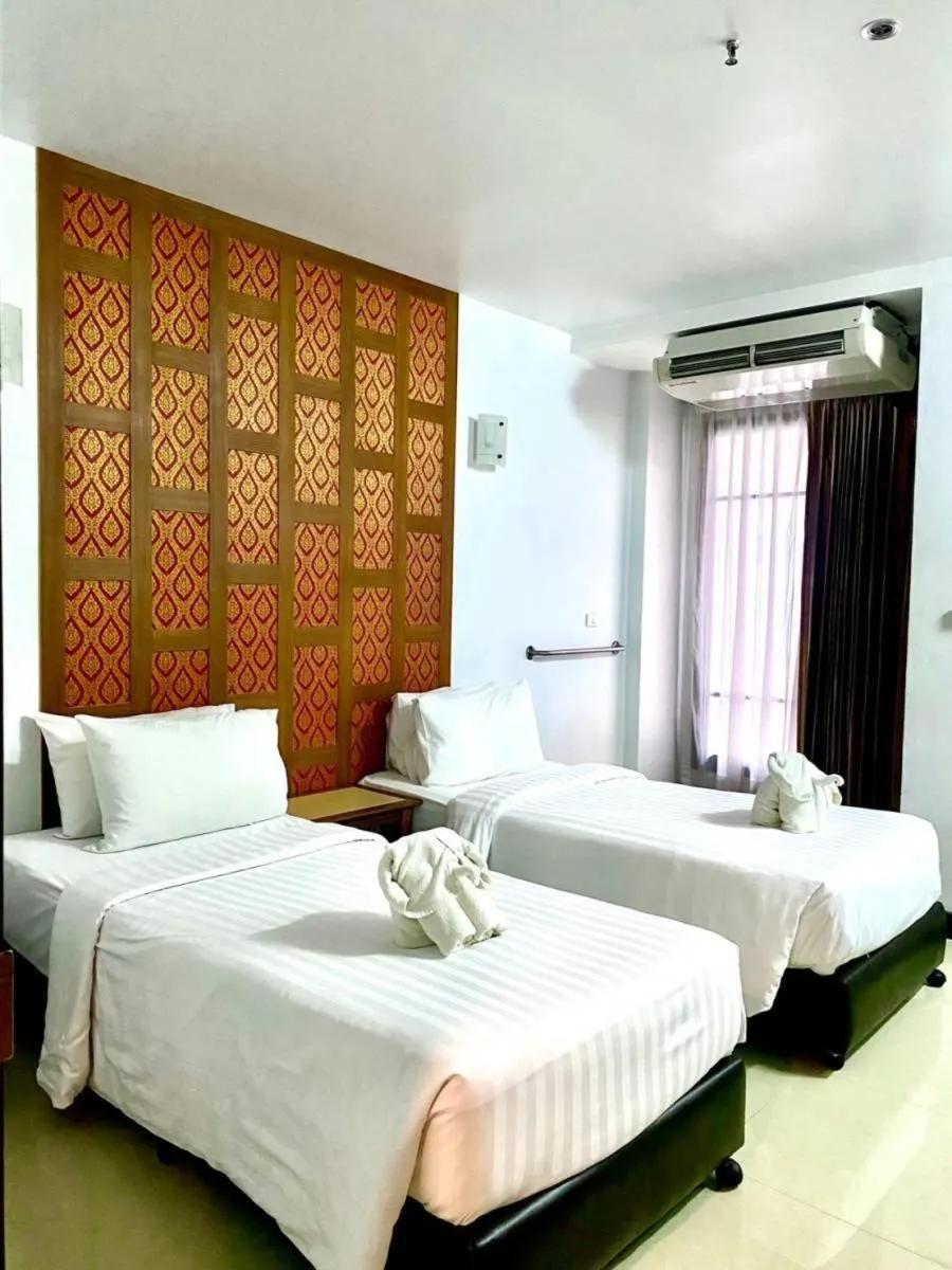 Bed in New Siam Palace Ville Hotel