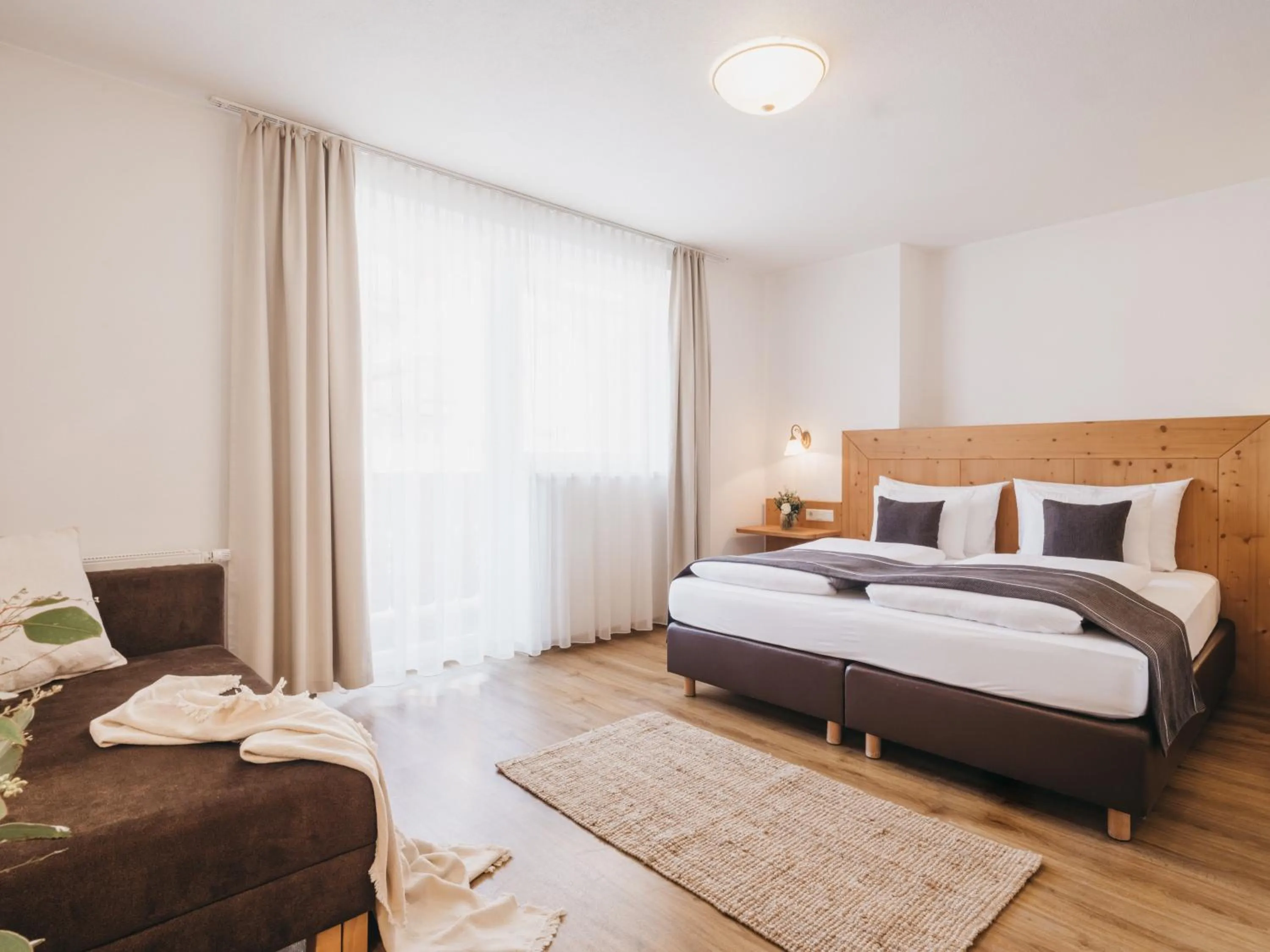 Bed in Hotel Vier Jahreszeiten by VAYA