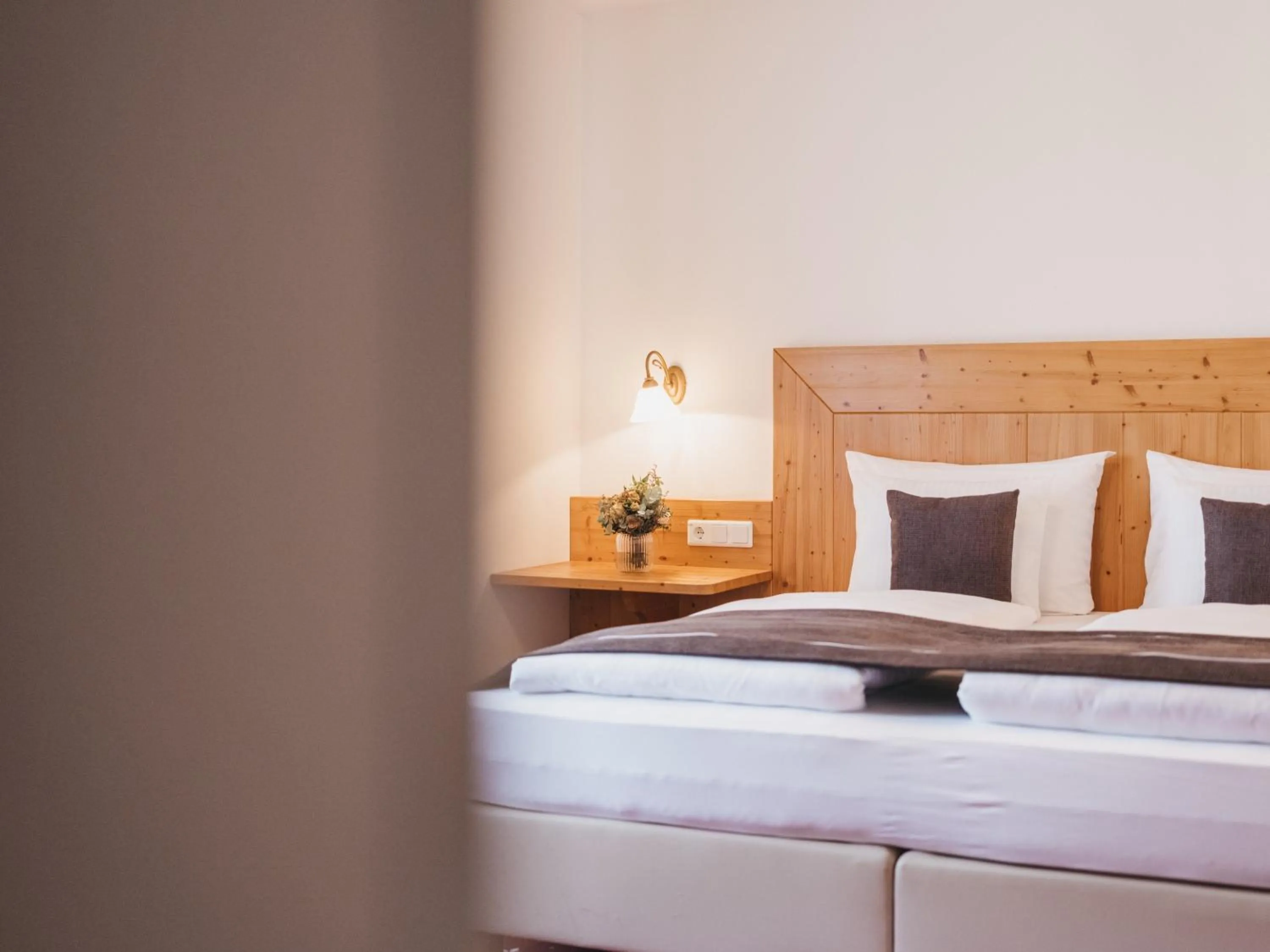 Bed in Hotel Vier Jahreszeiten by VAYA