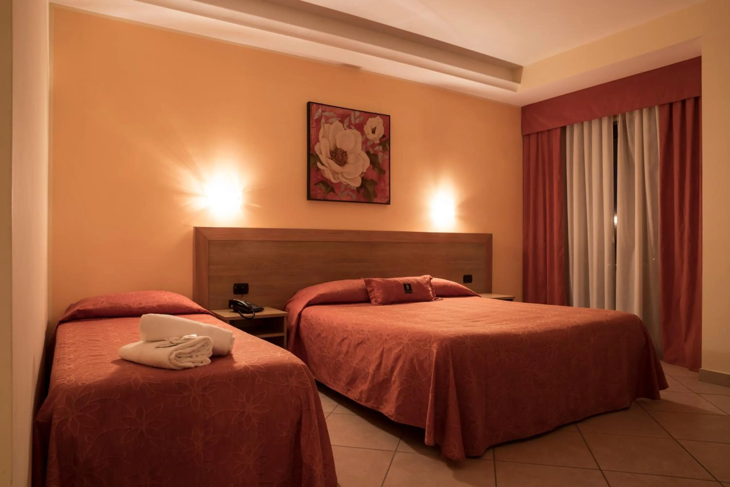 Bed in Manhattan Village Hotel