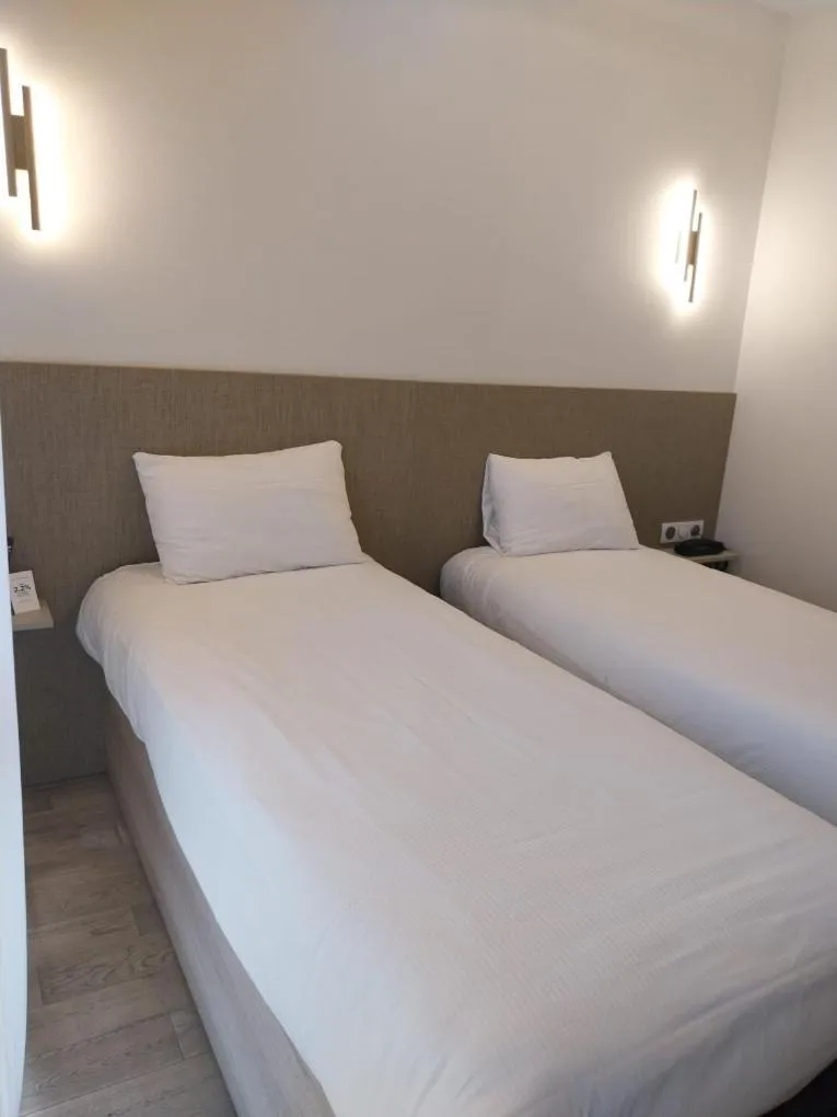 Bed in Logis Hôtel Saint Guirec Et De La Plage