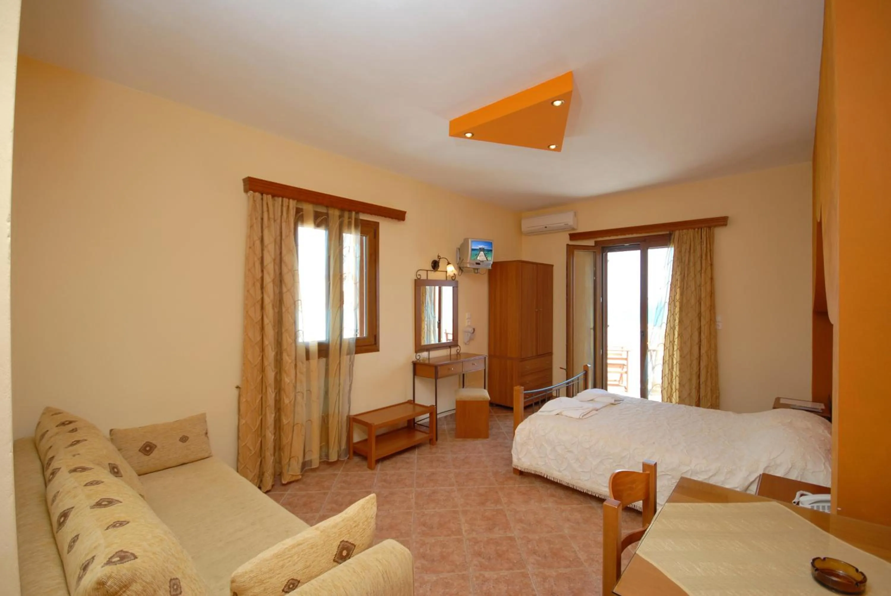 Kitchen or kitchenette, Bed in Golden Sun Hotel