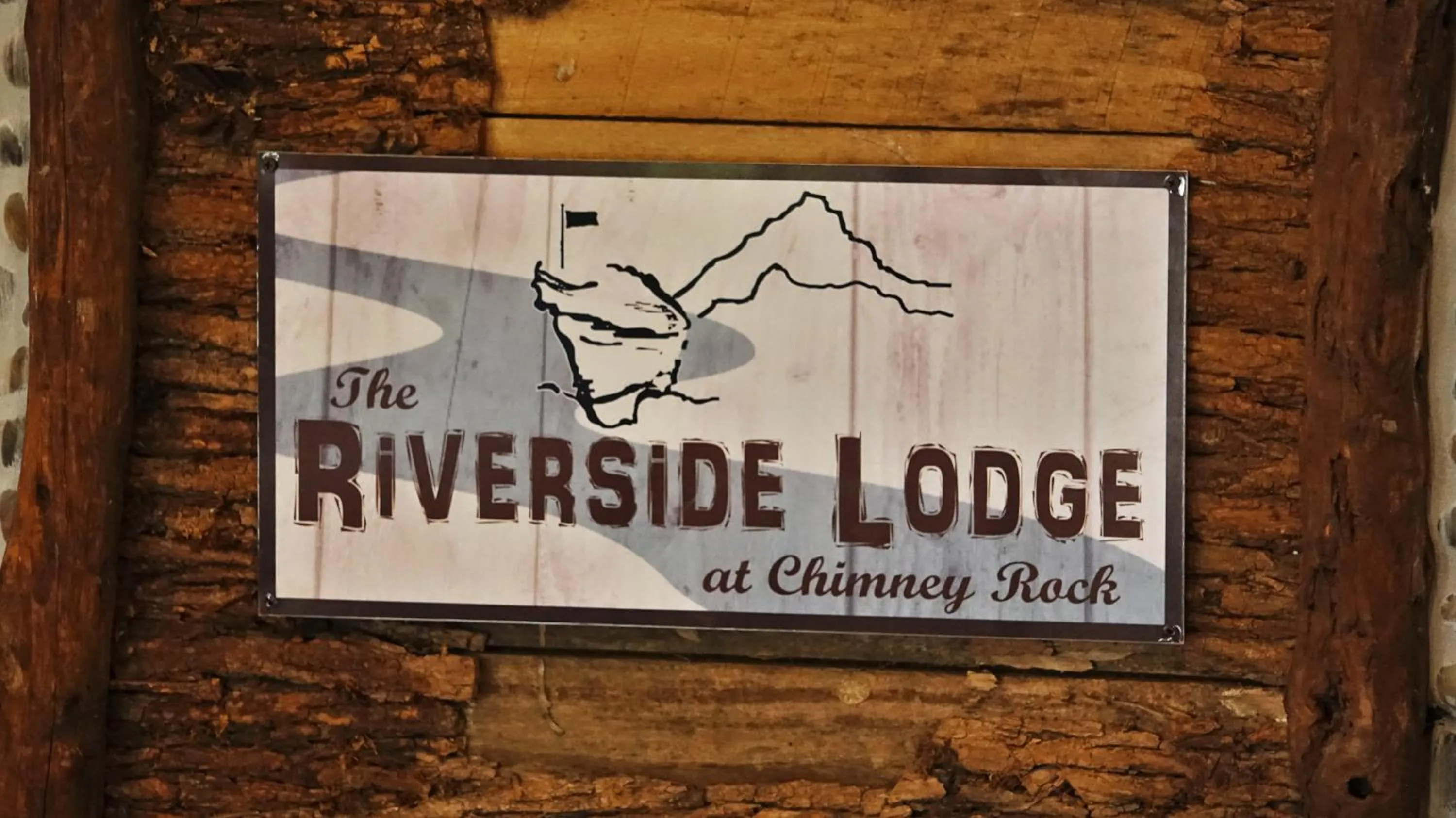 Property logo or sign in Riverside Lodge at Chimney Rock