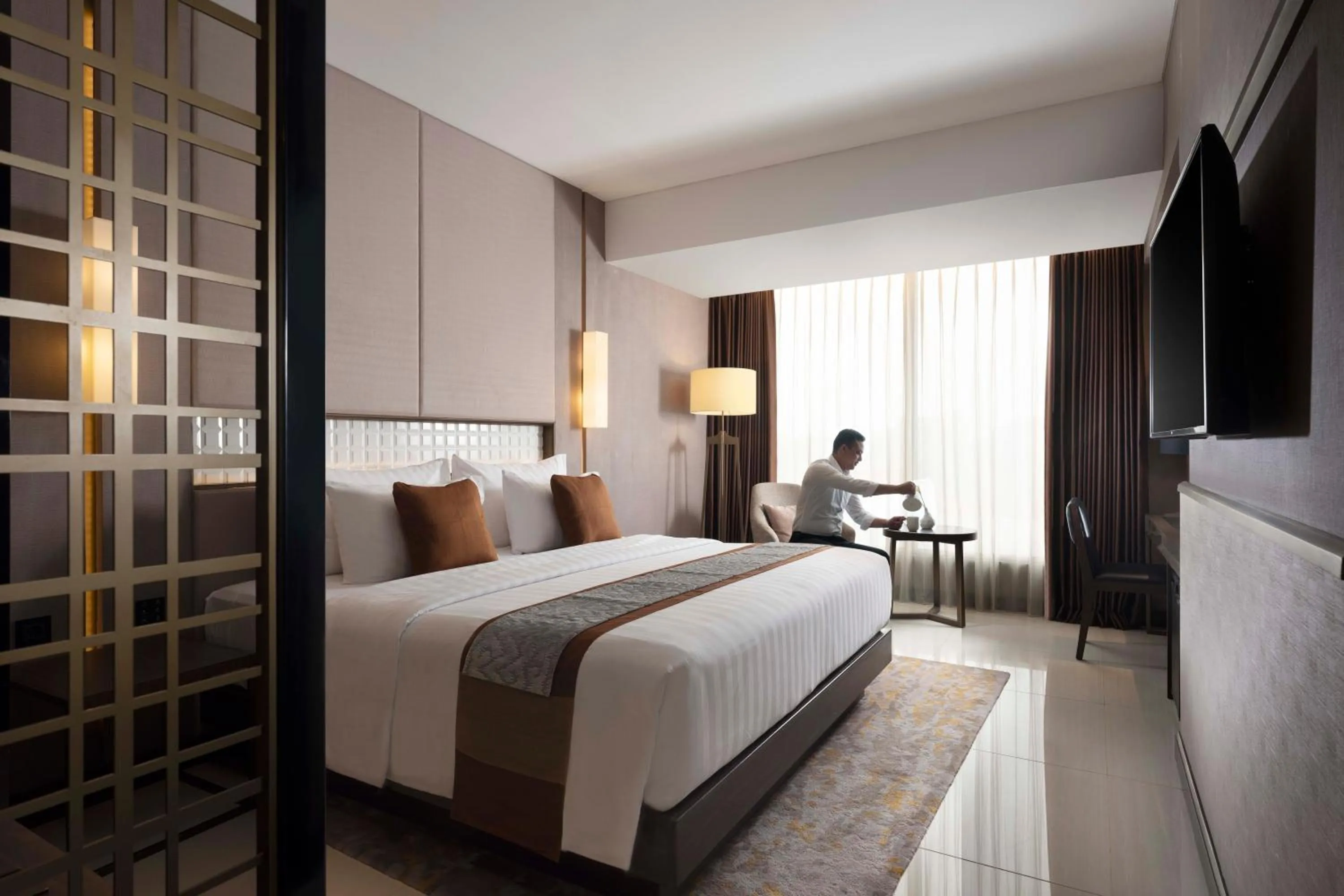 Bed in GRAMM HOTEL by Ambarrukmo Yogyakarta