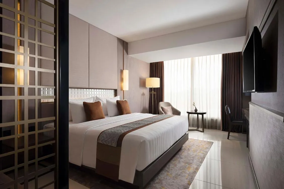 Bed in GRAMM HOTEL by Ambarrukmo Yogyakarta