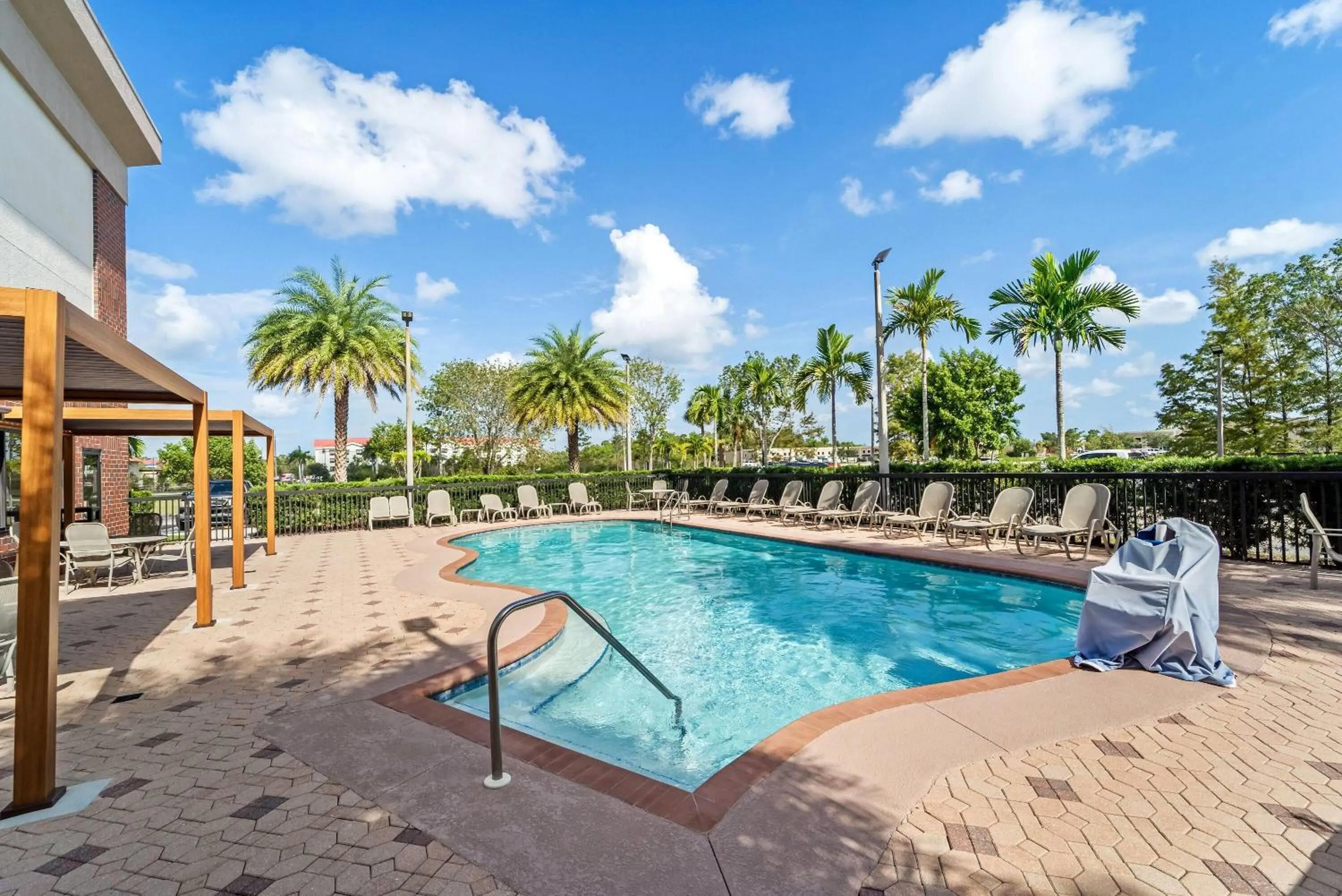 Swimming pool in Days Inn & Suites by Wyndham Fort Myers Near JetBlue Park