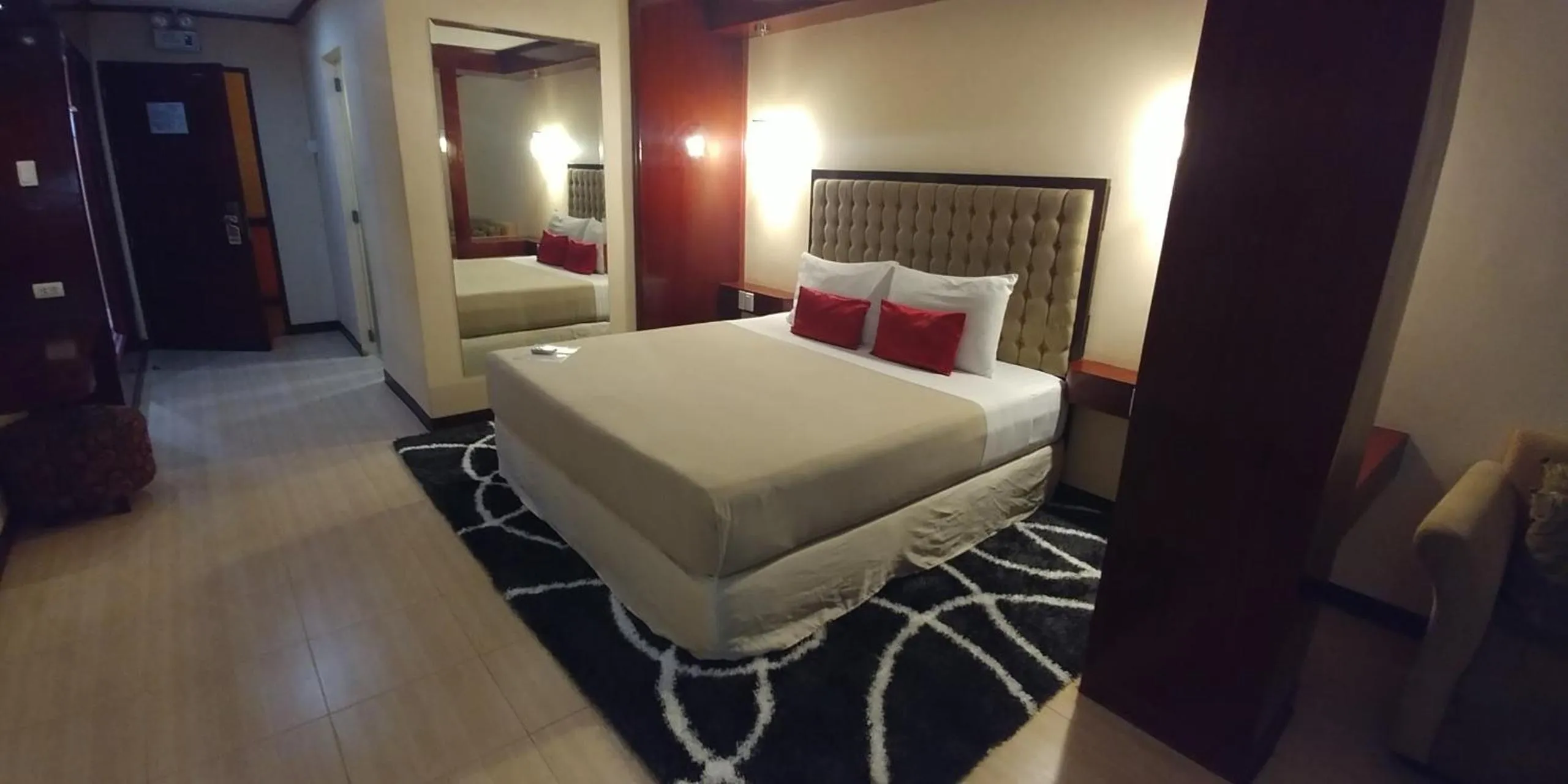 Photo of the whole room, Bed in Cebu Dulcinea Hotel and Suites-MACTAN AIRPORT HOTEL