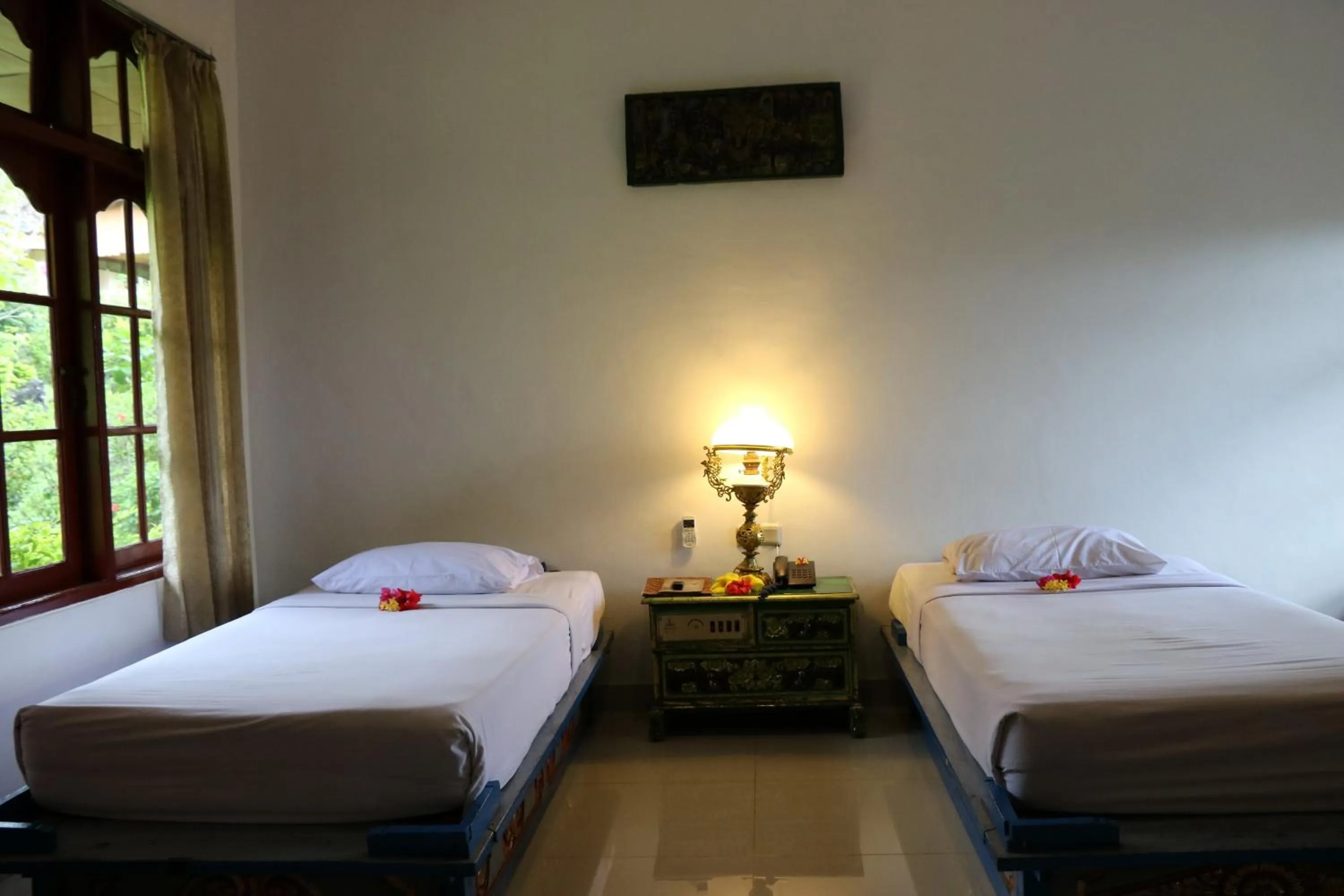 Bed in Puri Bunga Beach Cottages