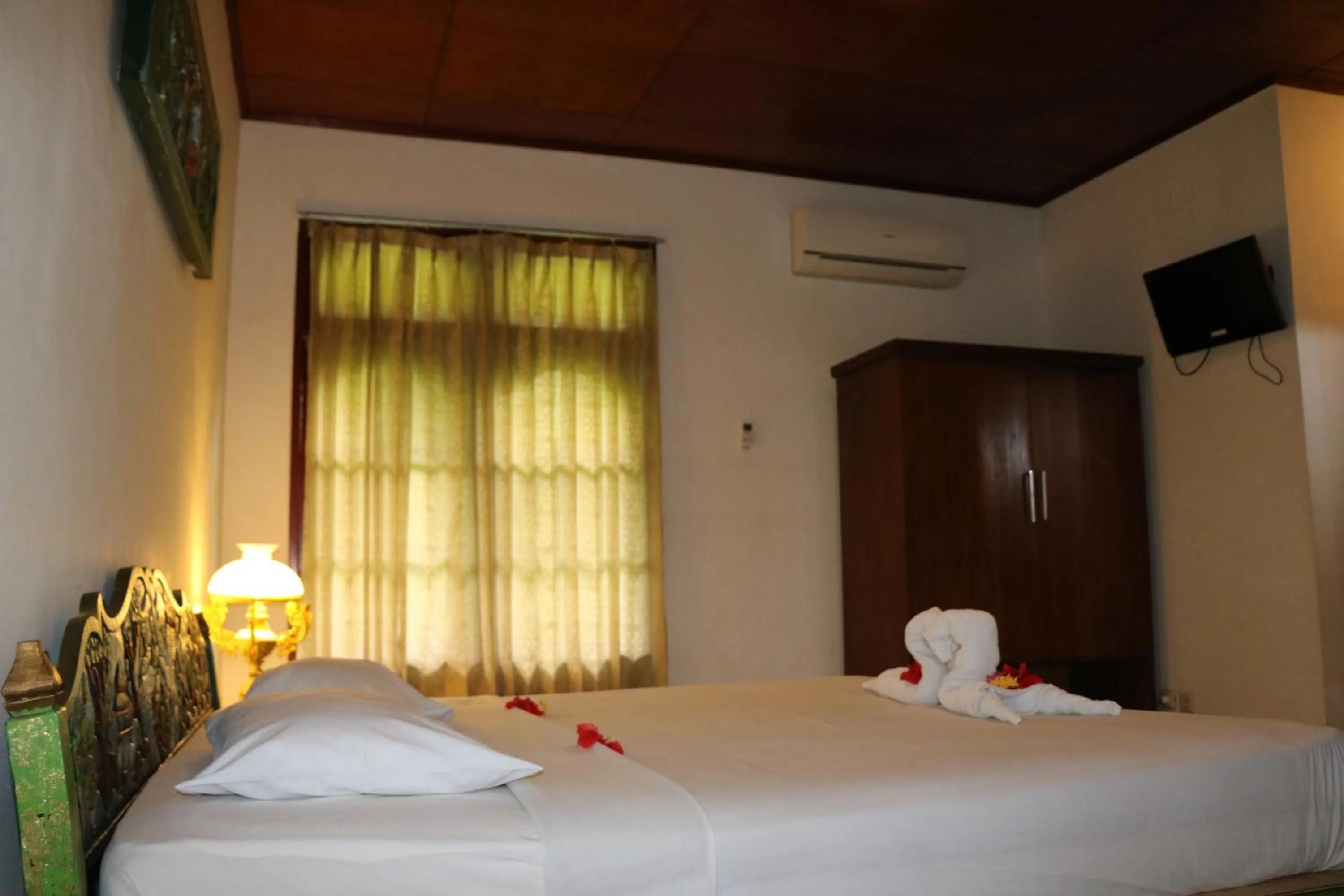 Bed in Puri Bunga Beach Cottages
