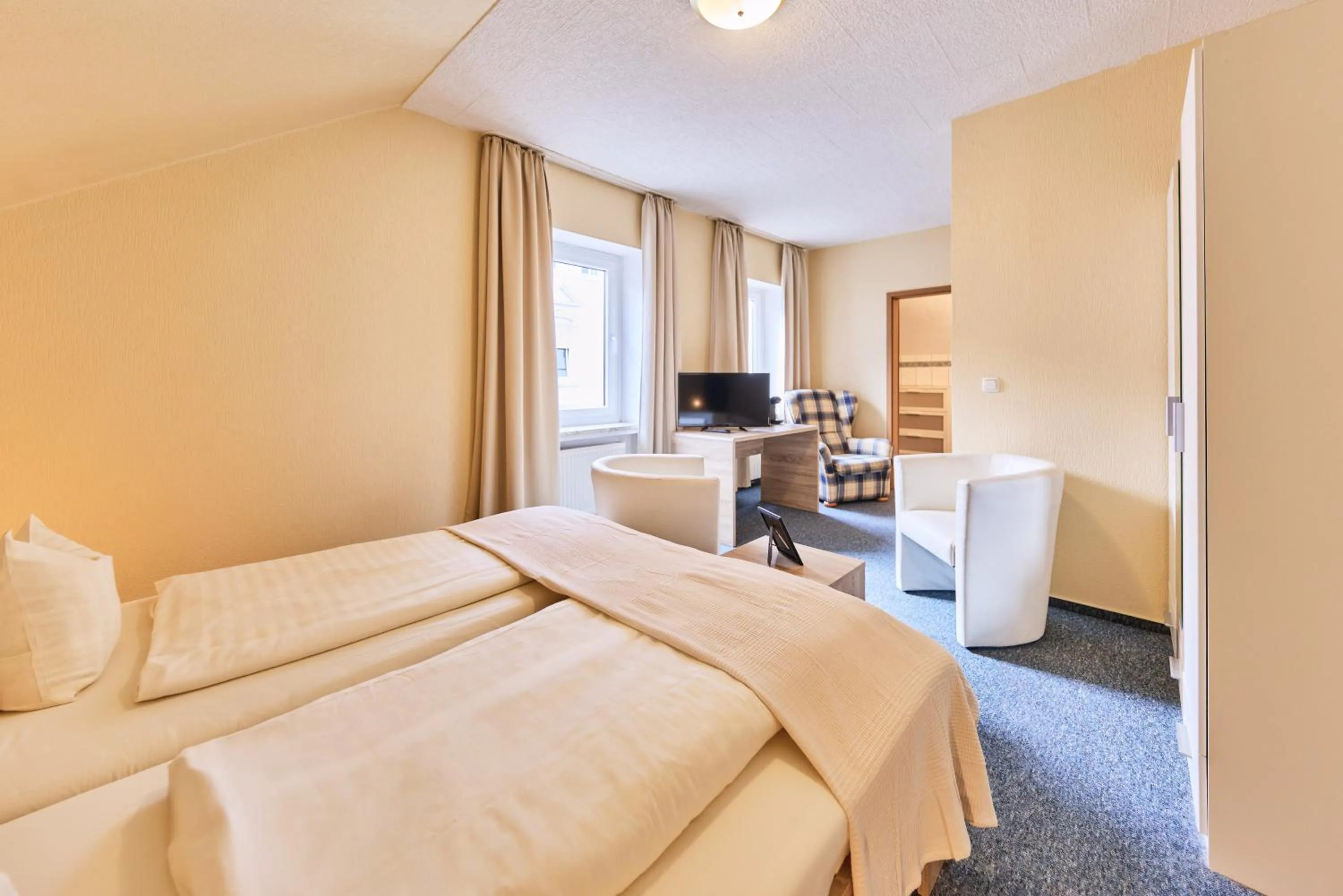 Seating area, Bed in arador CITY Hotel