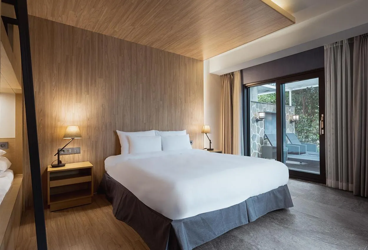 Bed in The Suites Hotel Jeju