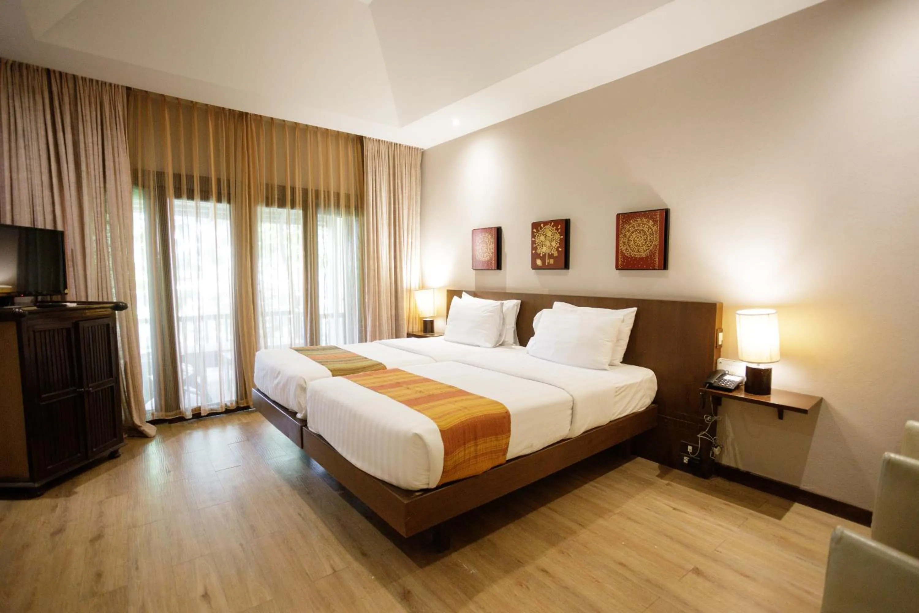 Bed in Lanna Dusita Riverside Boutique Resort