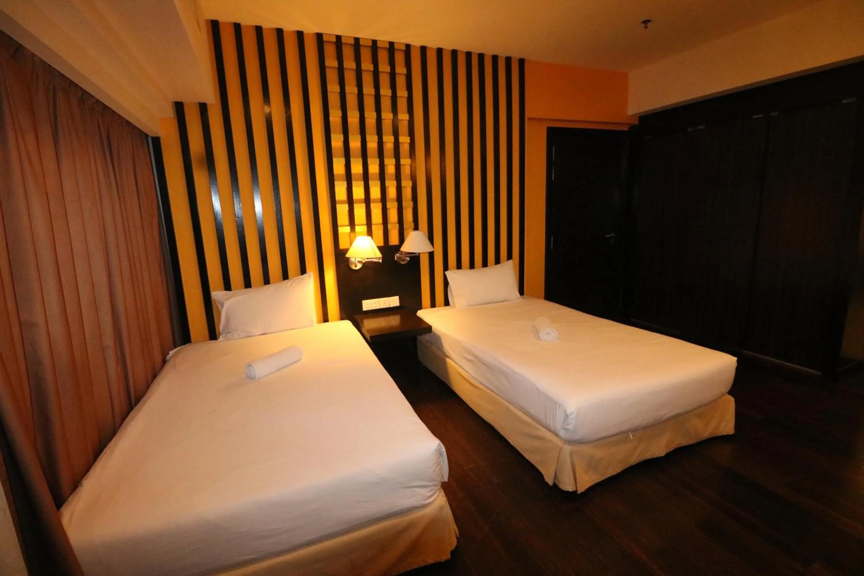 Bed in Raintree Resort Suites