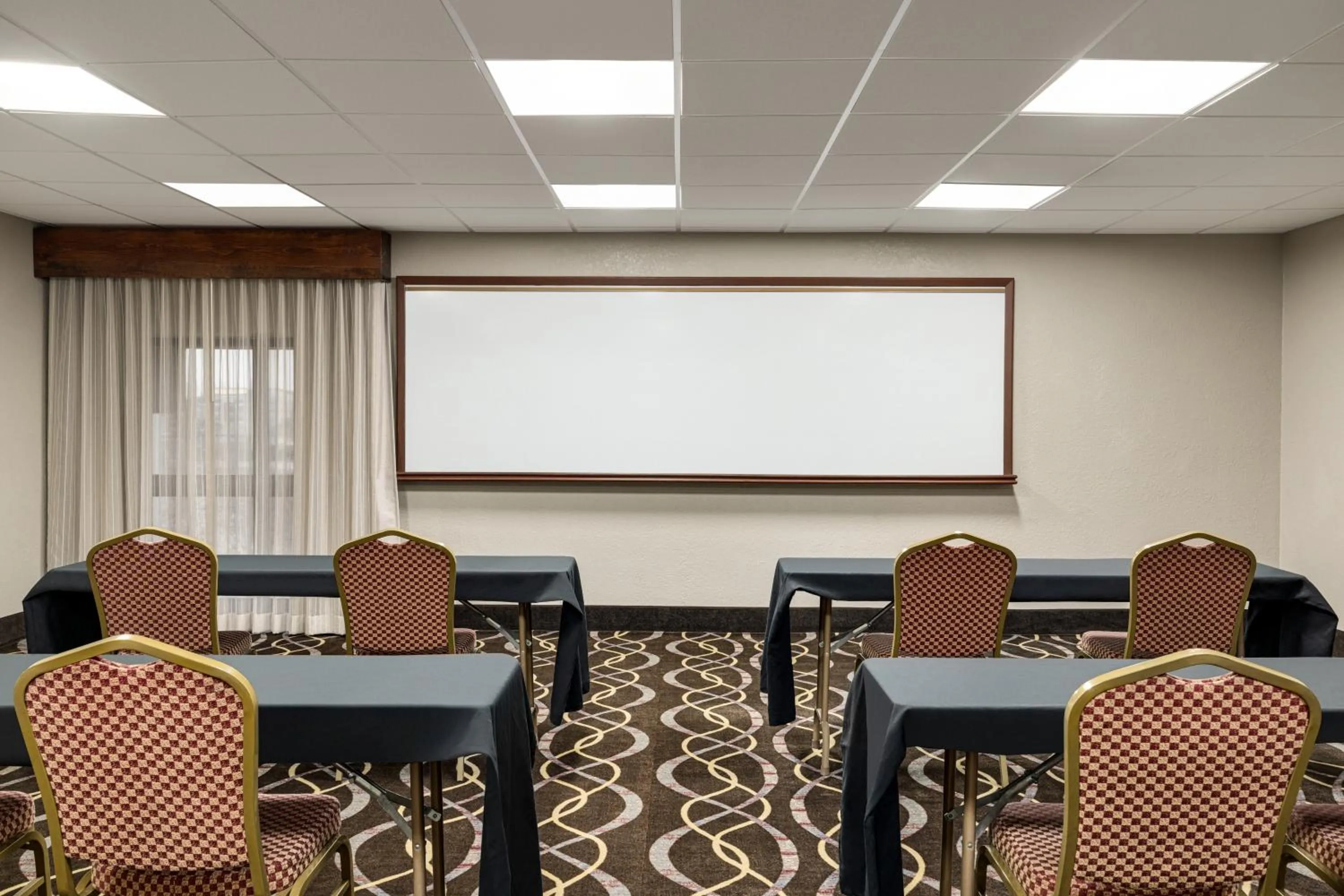 Meeting/conference room in AmericInn by Wyndham Grand Rapids Airport North