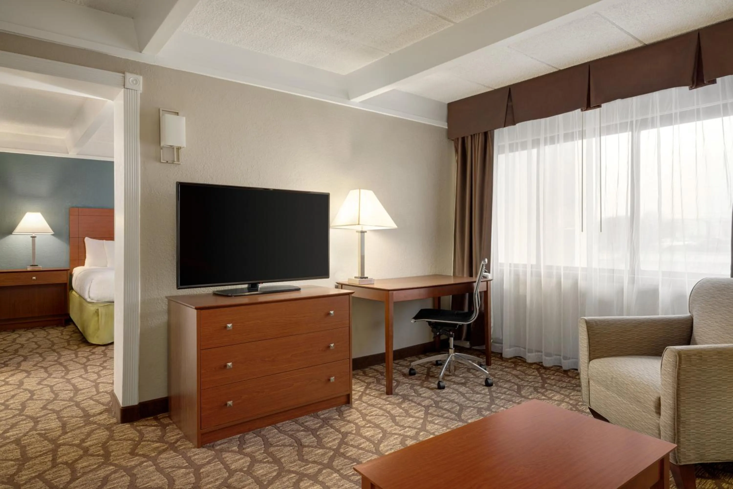 Living room in AmericInn by Wyndham Grand Rapids Airport North