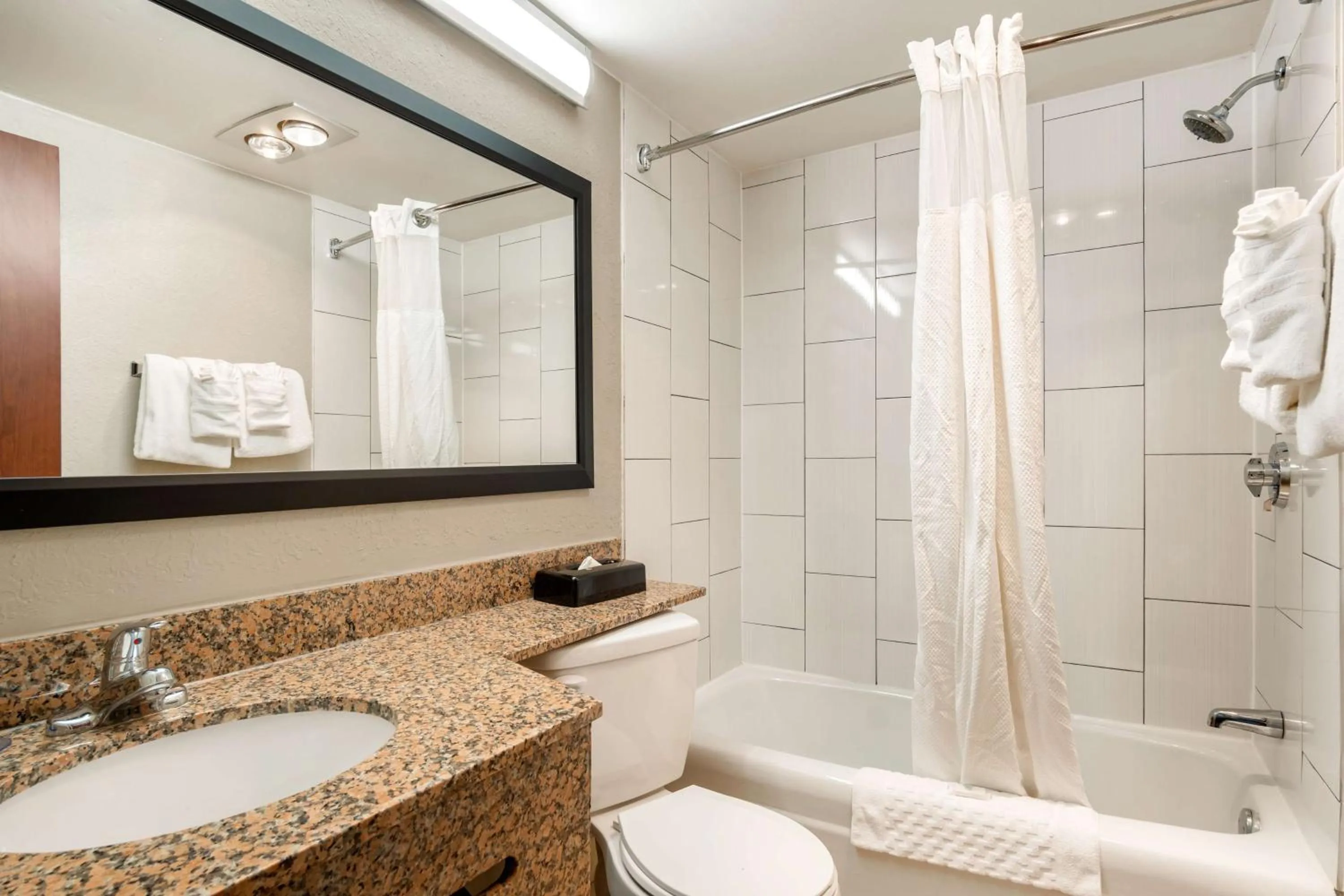 Bathroom in AmericInn by Wyndham Grand Rapids Airport North