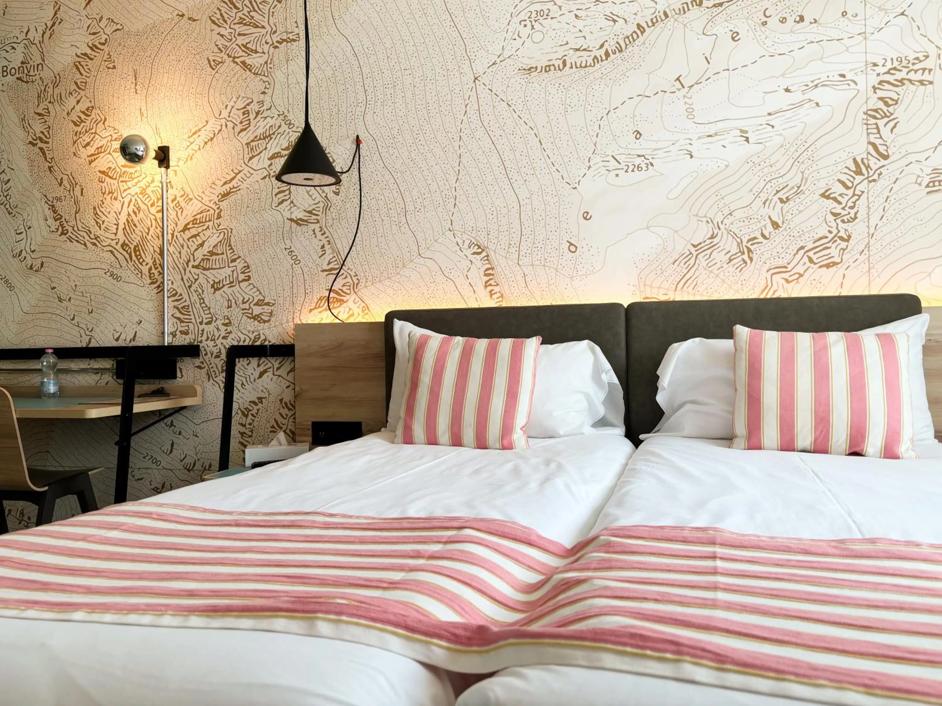 Bed in Nonanteneuf appart hōtel Sierre - contactless check-in