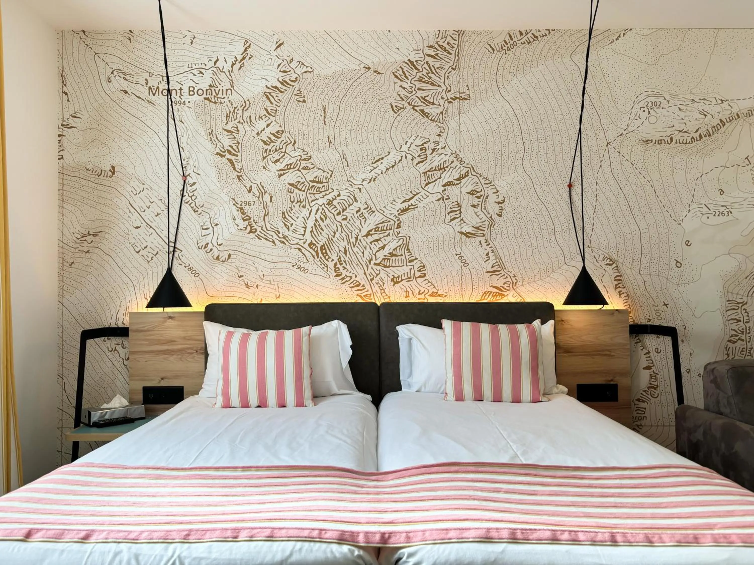 Bed in Nonanteneuf appart hōtel Sierre - contactless check-in