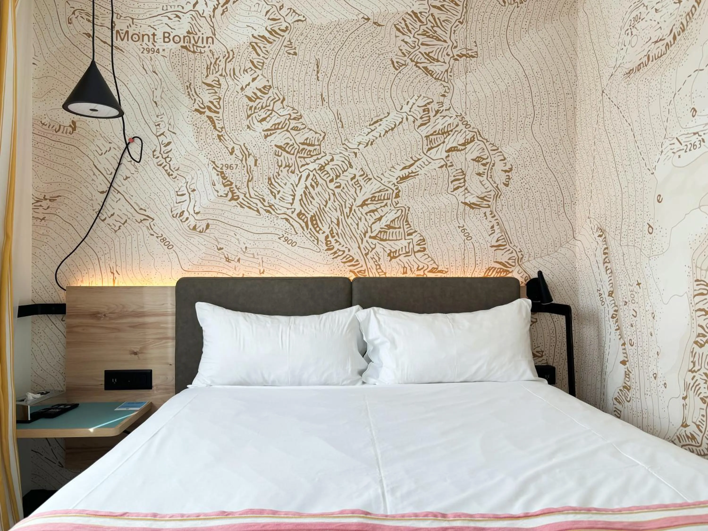 Bed in Nonanteneuf appart hōtel Sierre - contactless check-in