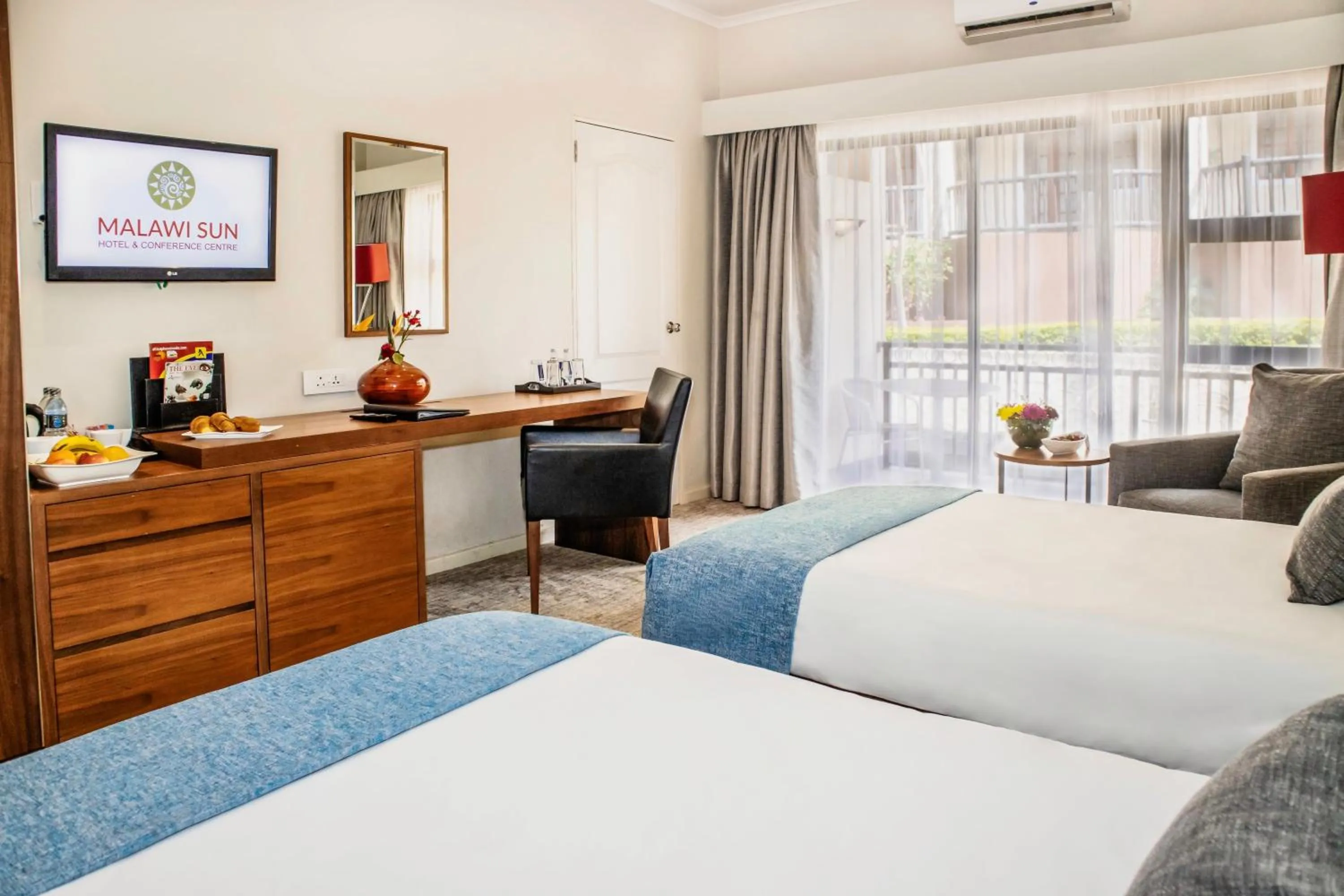 Photo of the whole room, Bed in Malawi Sun Hotel & Conference Centre