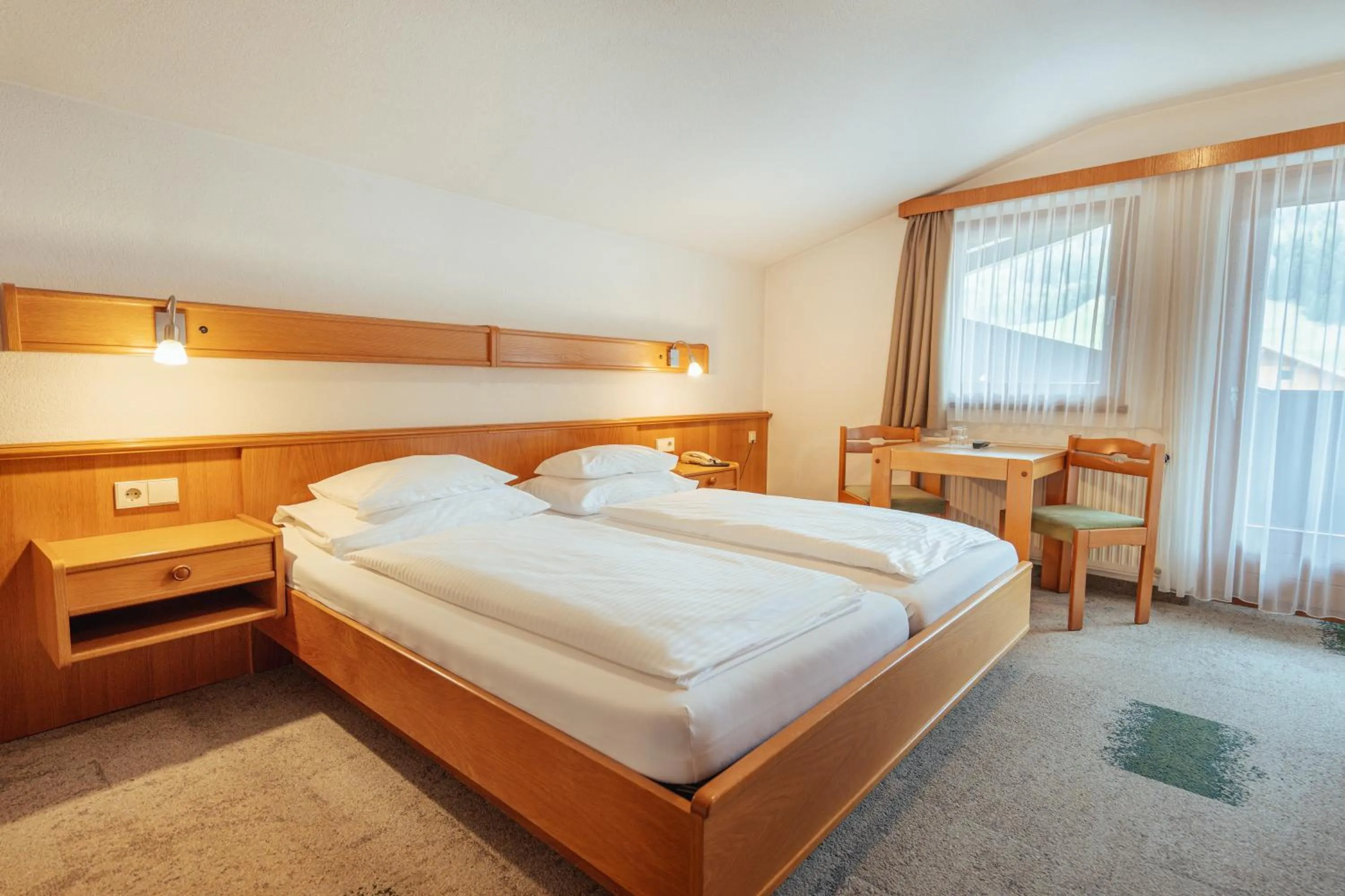 Seating area, Bed in Hotel Gesser