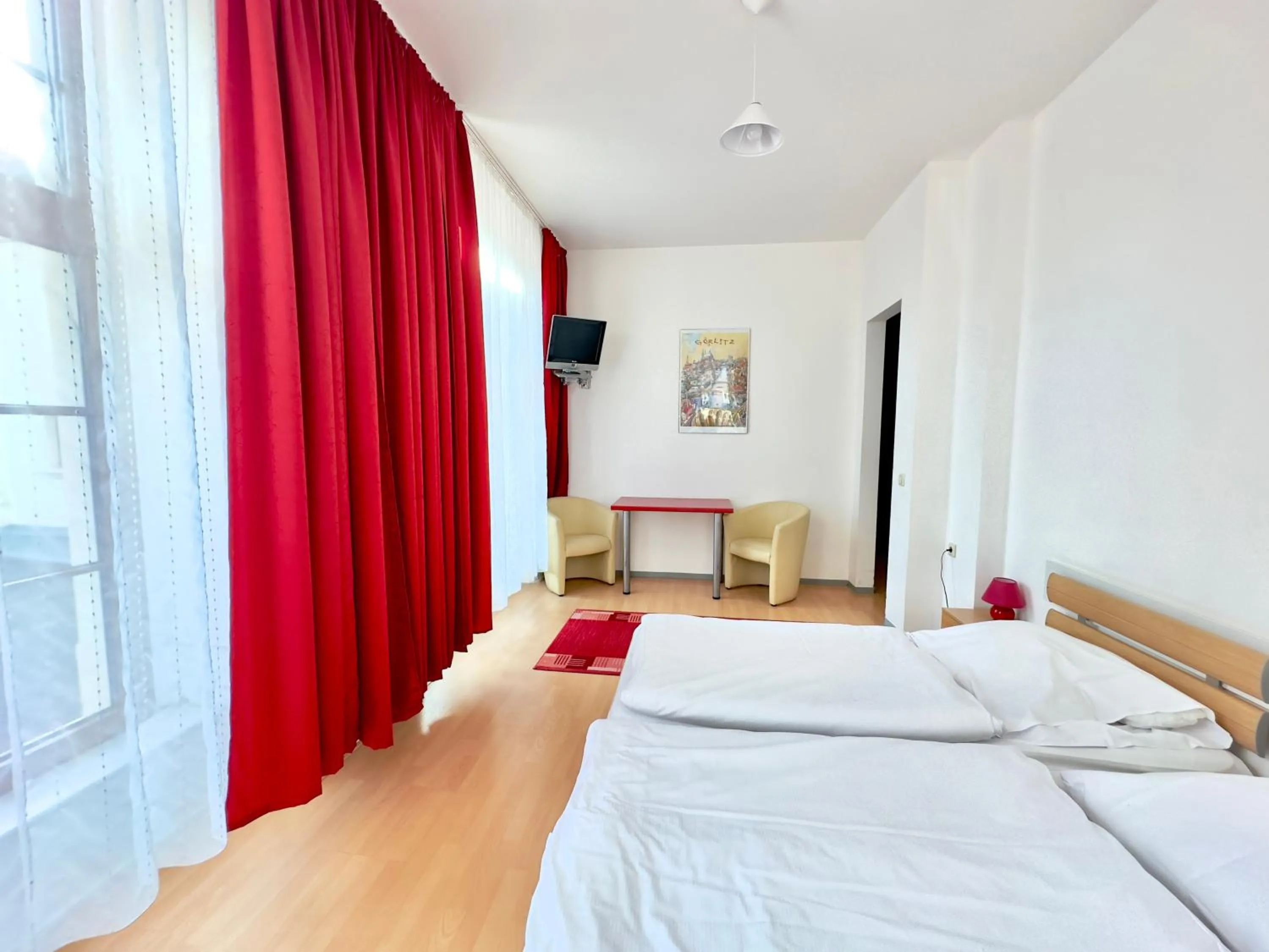 Seating area, Bed in Picobello Pension