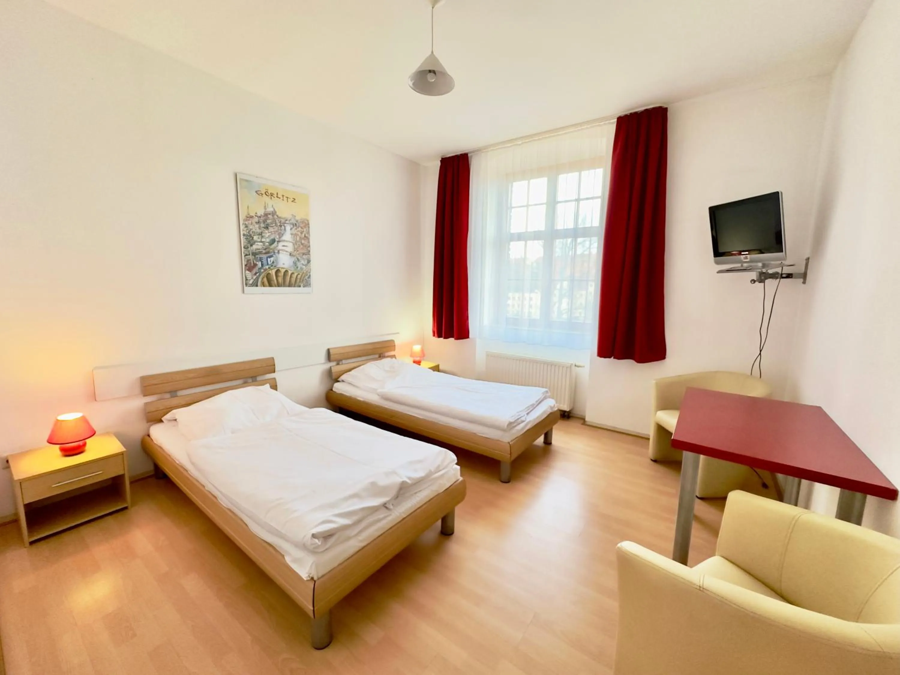 Seating area, Bed in Picobello Pension