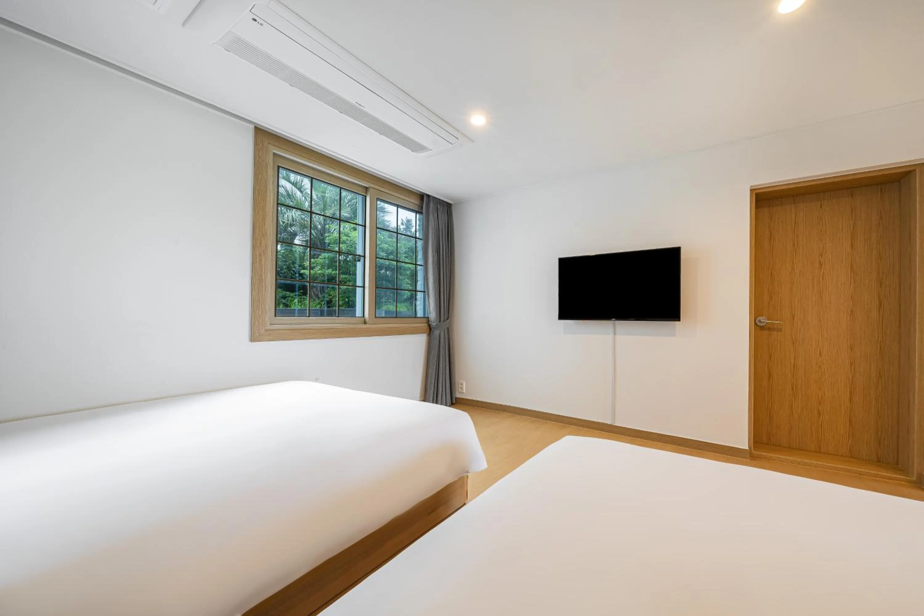 Bed in Heyy Seogwipo Hotel